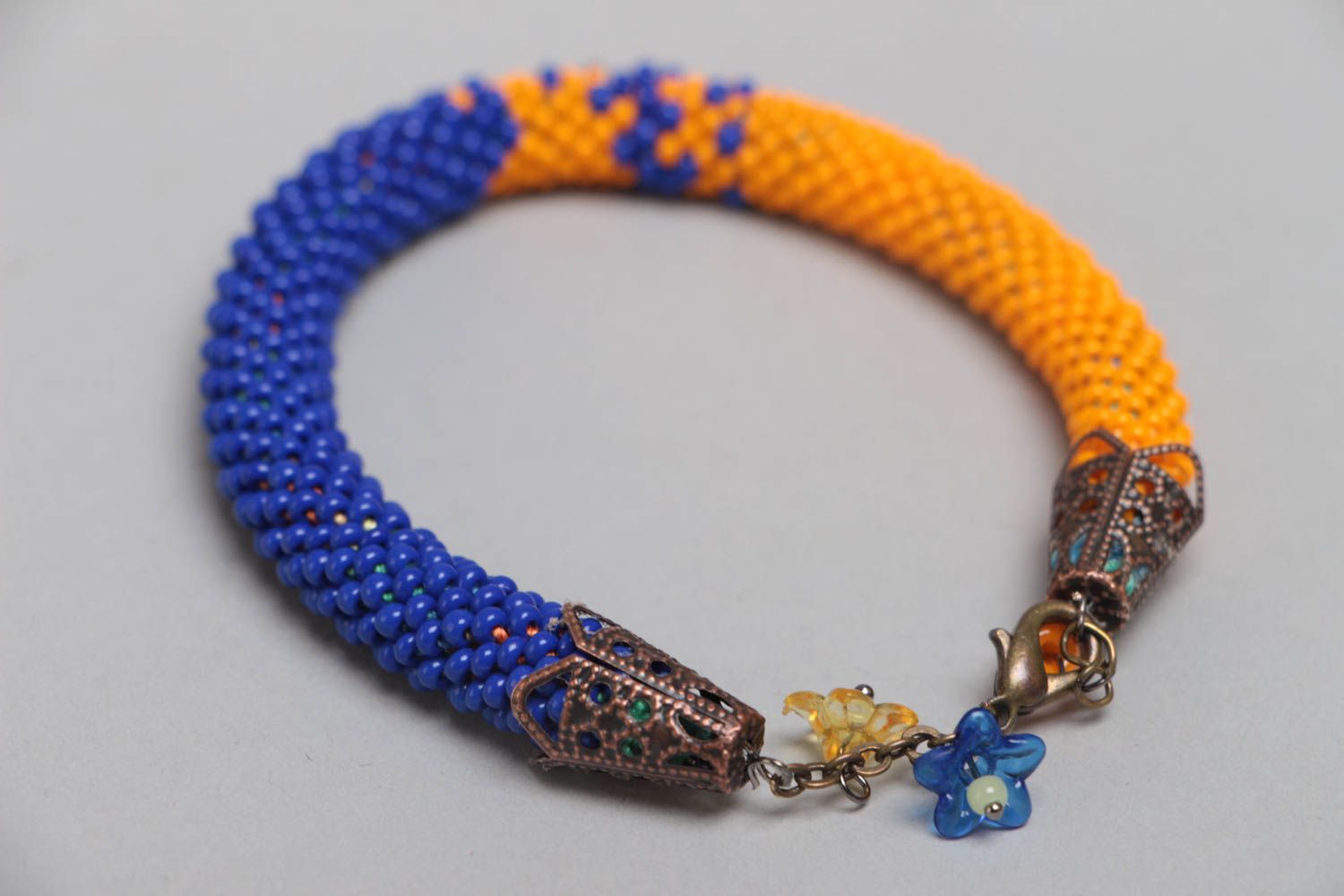Handmade designer blue and yellow beaded cord wrist bracelet with flower charms photo 3