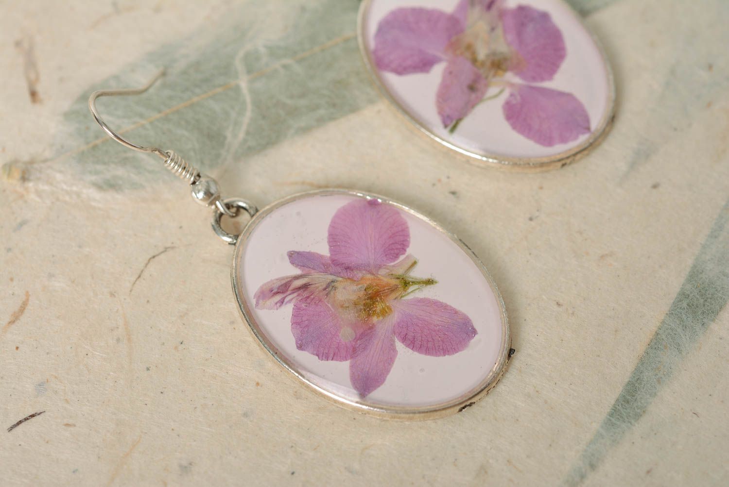 Handmade laconic oval dangle earrings with violet flowers in epoxy resin photo 4