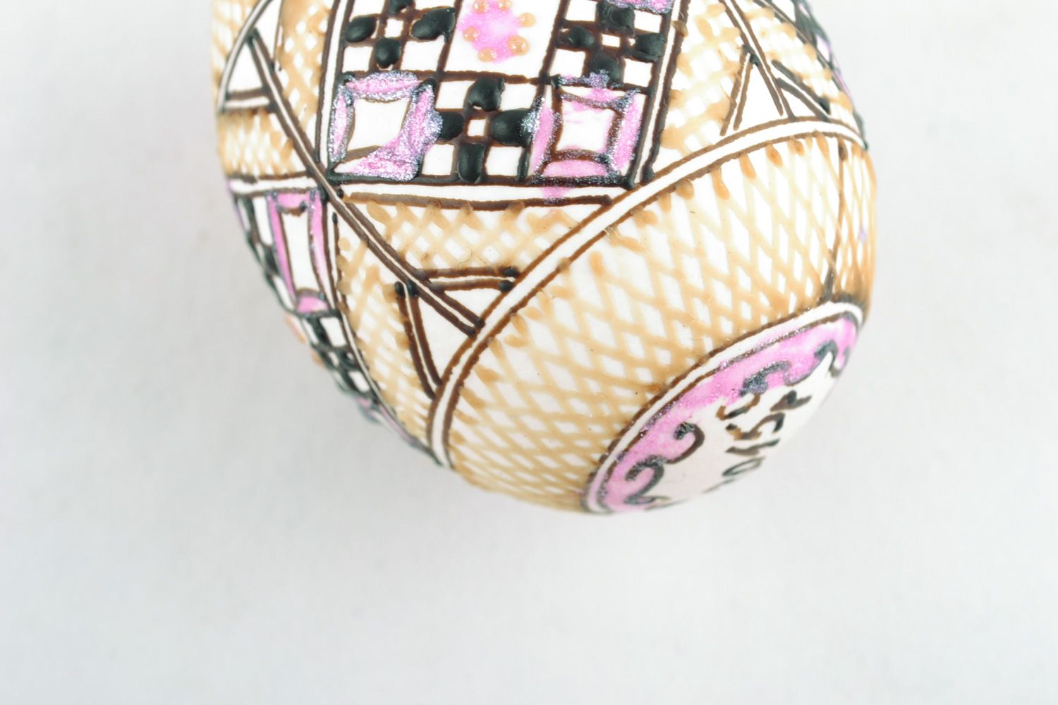 Handmade decorative Easter egg pysanka with wax painting in light color palette photo 3