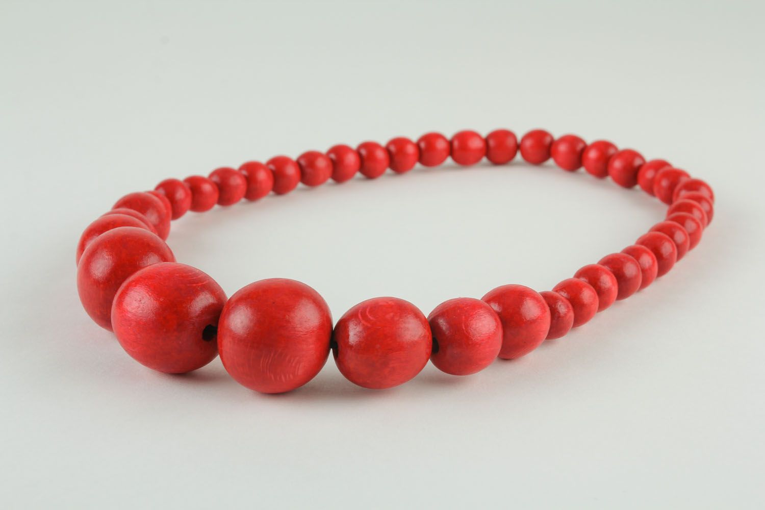 Red necklace made of large beads photo 1