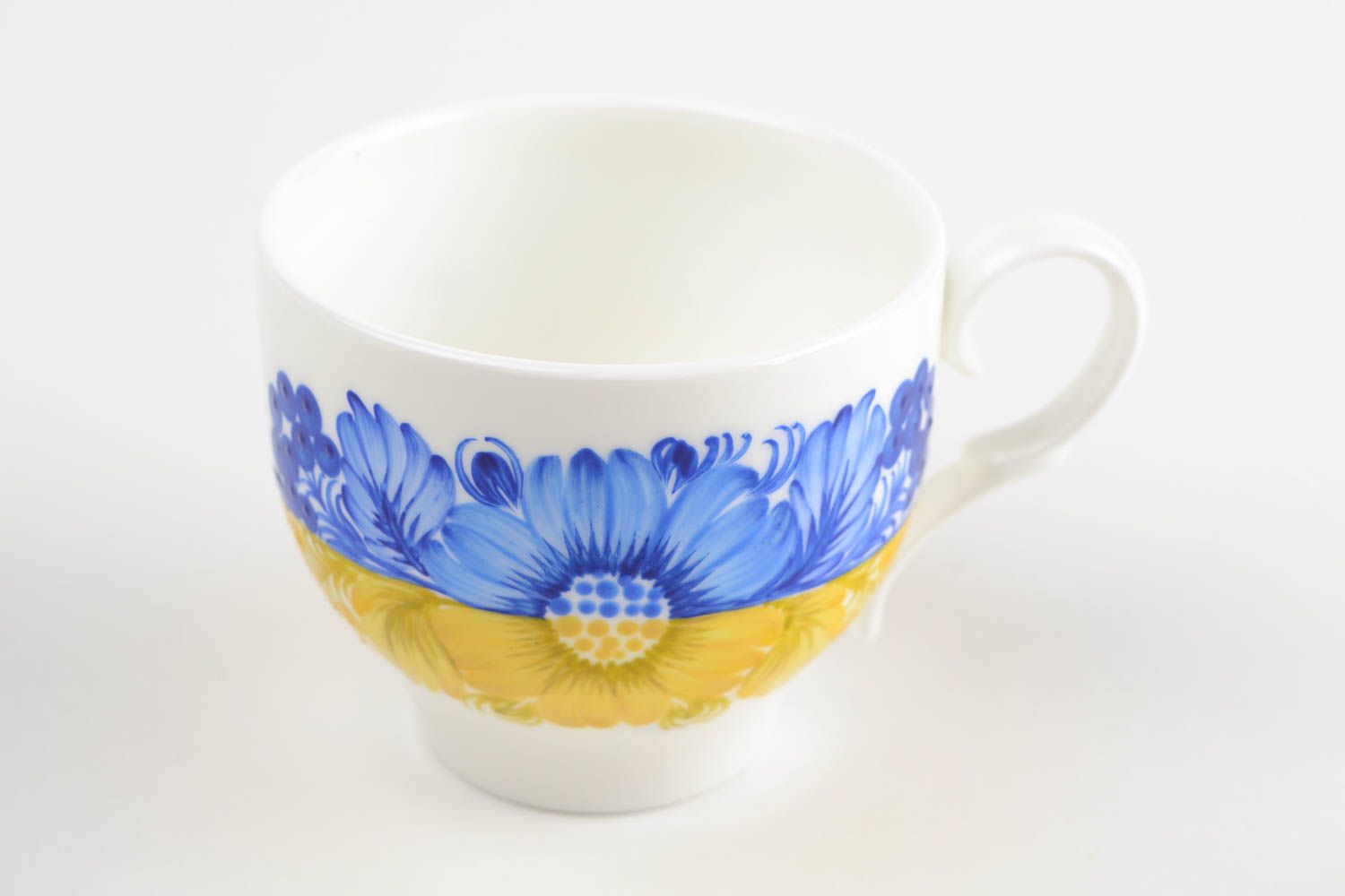 Porcelain teacup in white, yellow, and blue color with handle photo 3