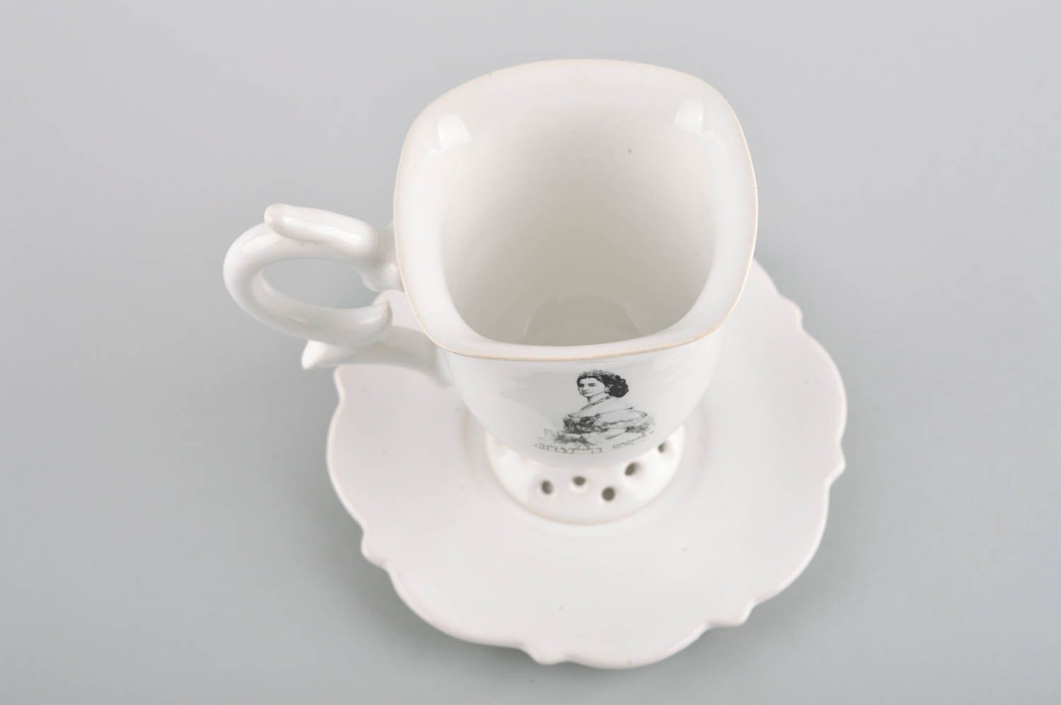 Elegant porcelain drinking cup on stand with handle and saucer in white color photo 3