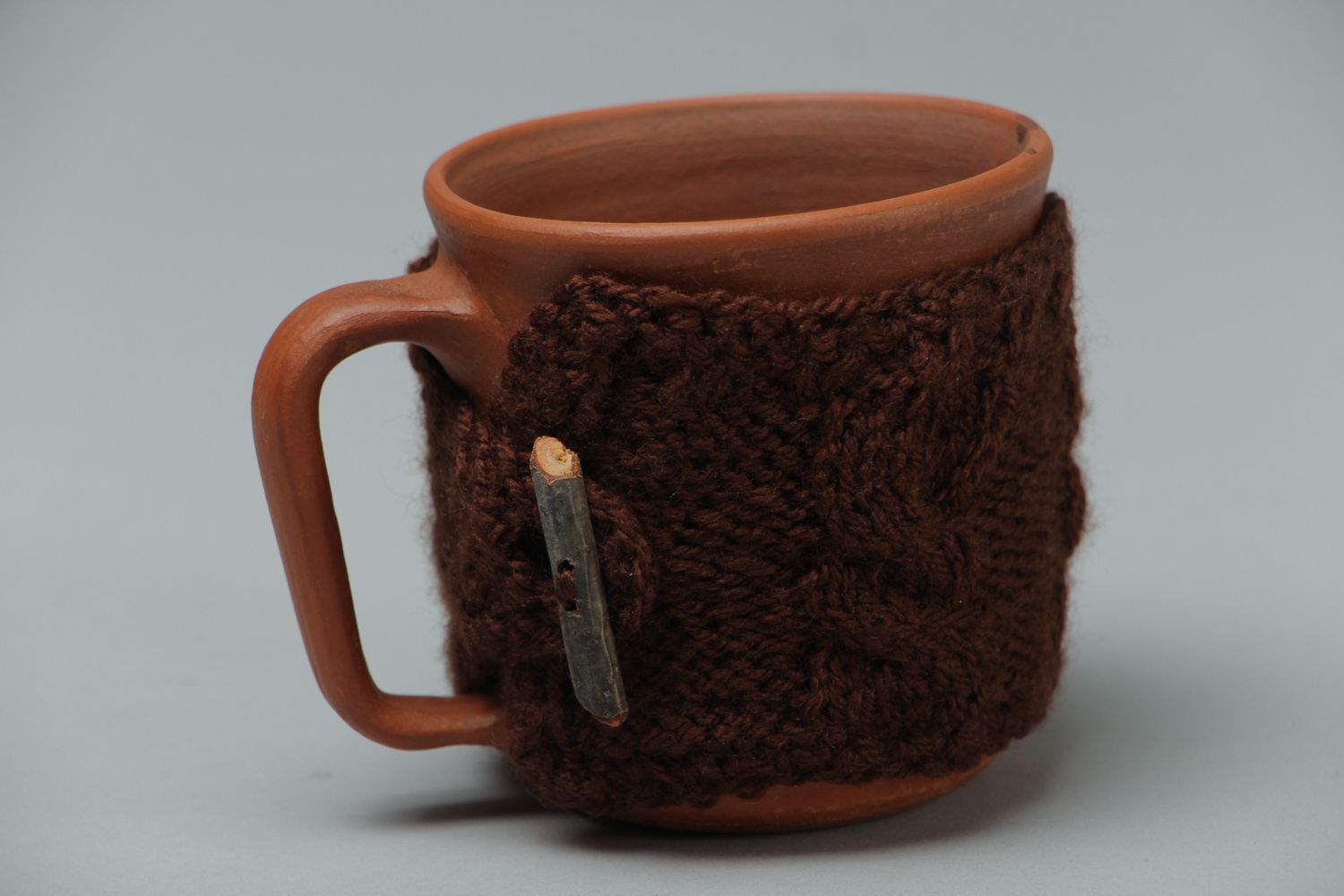 Ceramic cup in terracotta color with knitted back cozy cover photo 1