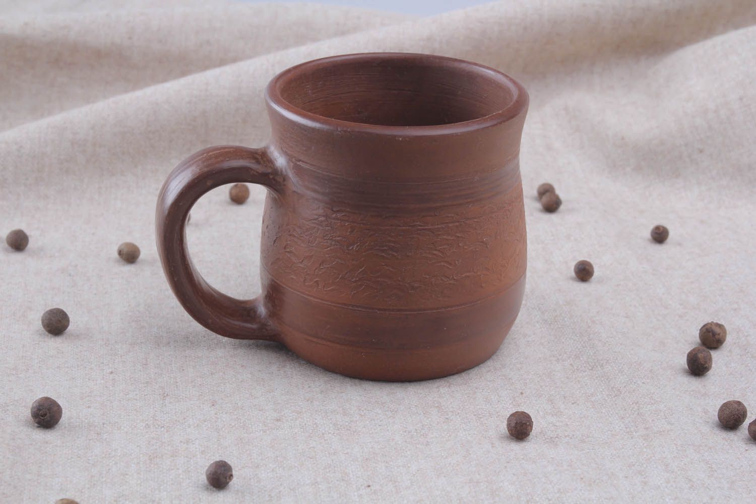 Brown clay coffee mug with handle and no pattern in the rustic shape photo 1