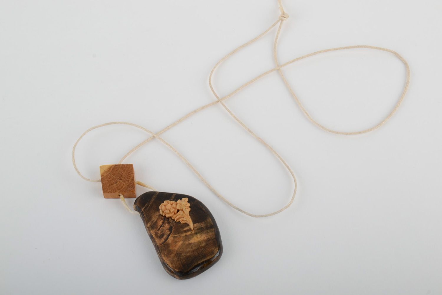 Beautiful handmade neck pendant carved of wood and varnished with synthetic cord photo 4