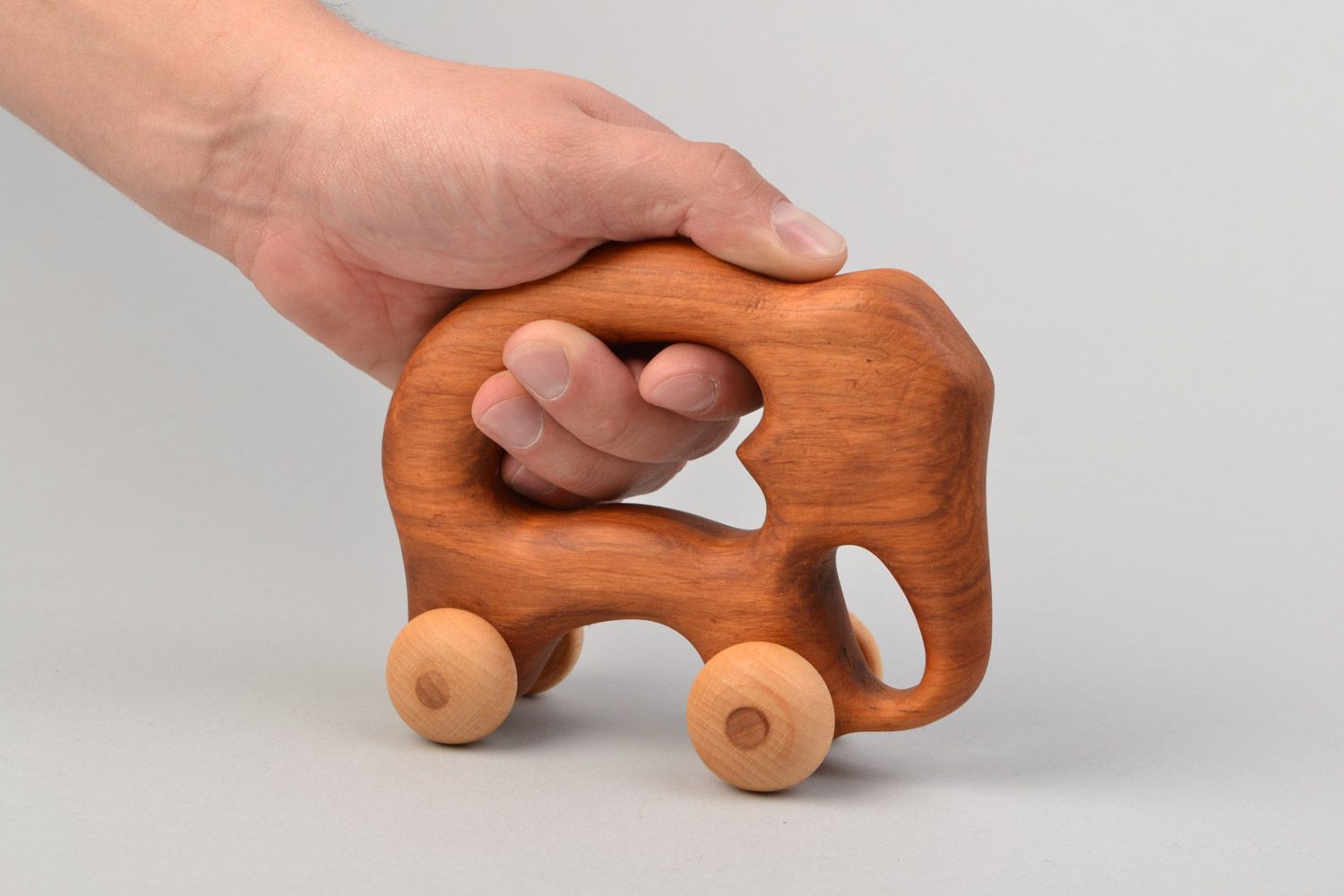 Handmade wooden wheeled toy elephant imbued with linseed oil for children photo 2