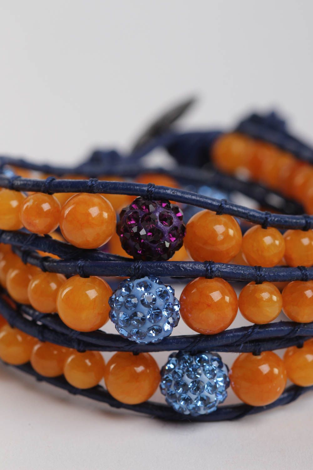 Three-layer orange beads strand bracelet on dark blue cord photo 3
