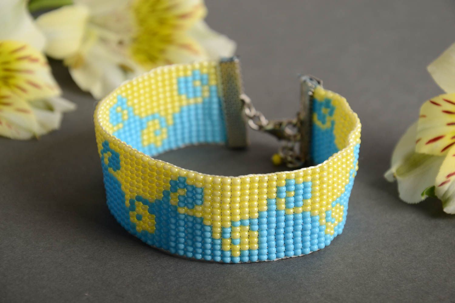 Handmade wide flat bead woven wrist bracelet with blue and yellow ornament photo 1