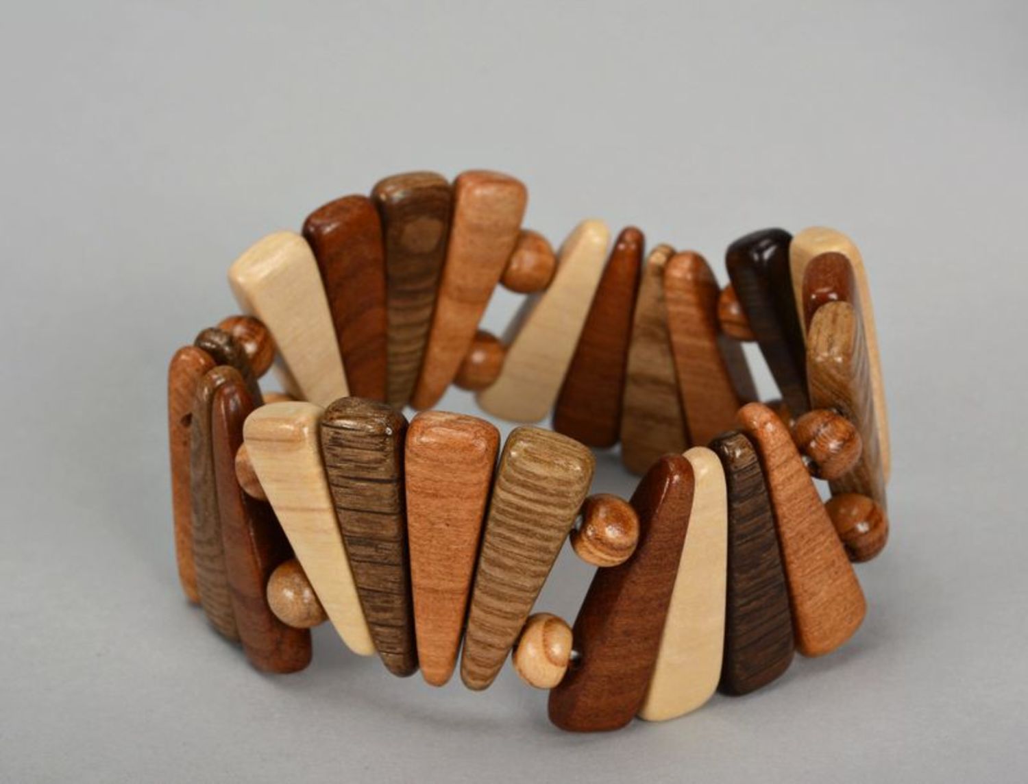 Fashionable wooden bracelet of brown color photo 1