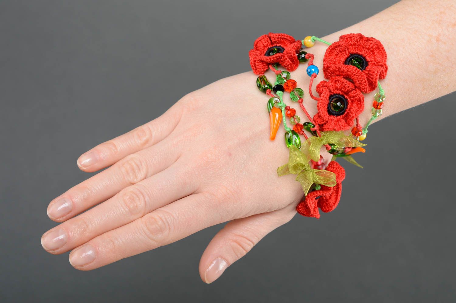 Red bracelet with crochet flowers photo 5