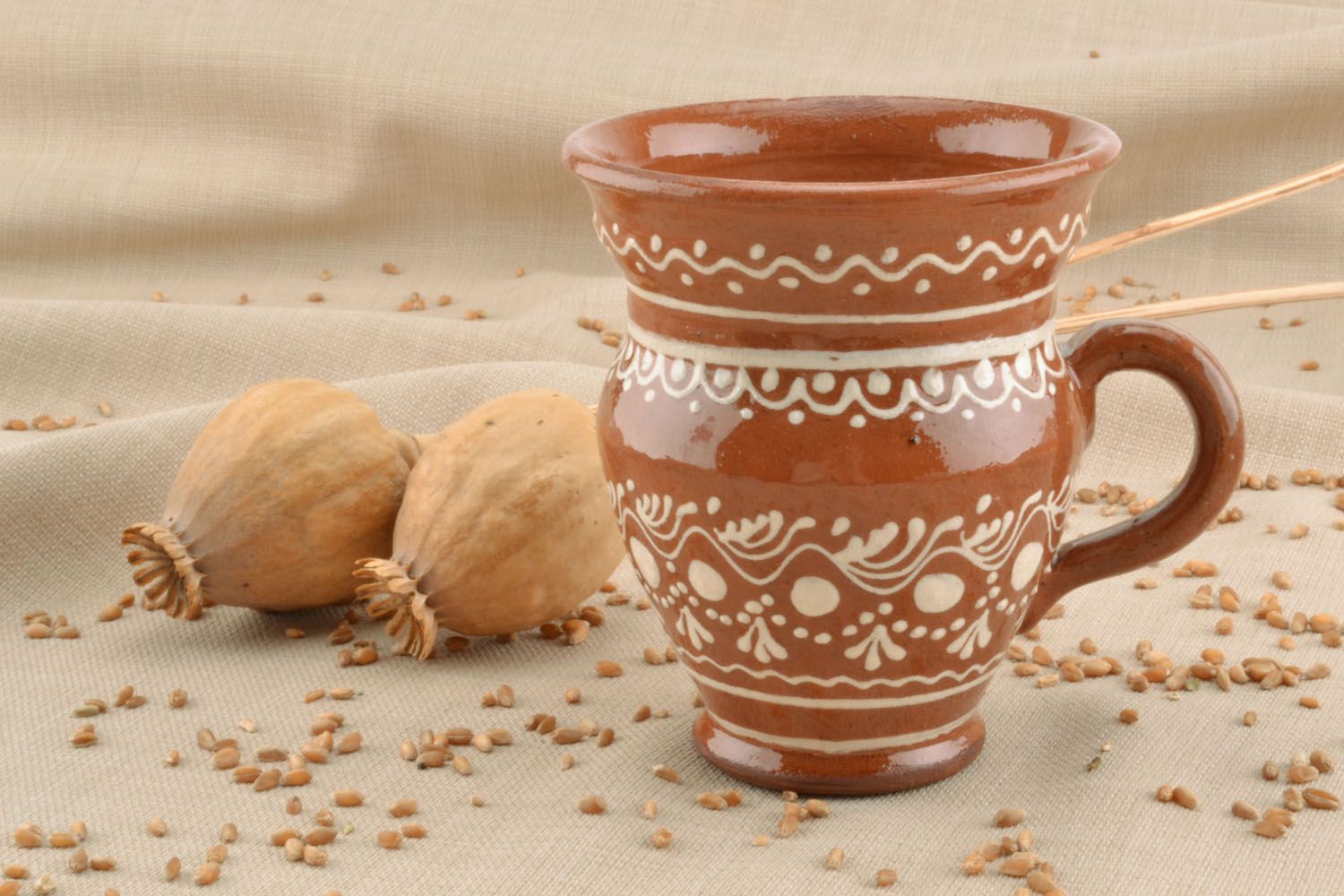 Decorative clay glazed drinking cup in pitcher shape with handle and white ethnic pattern photo 1