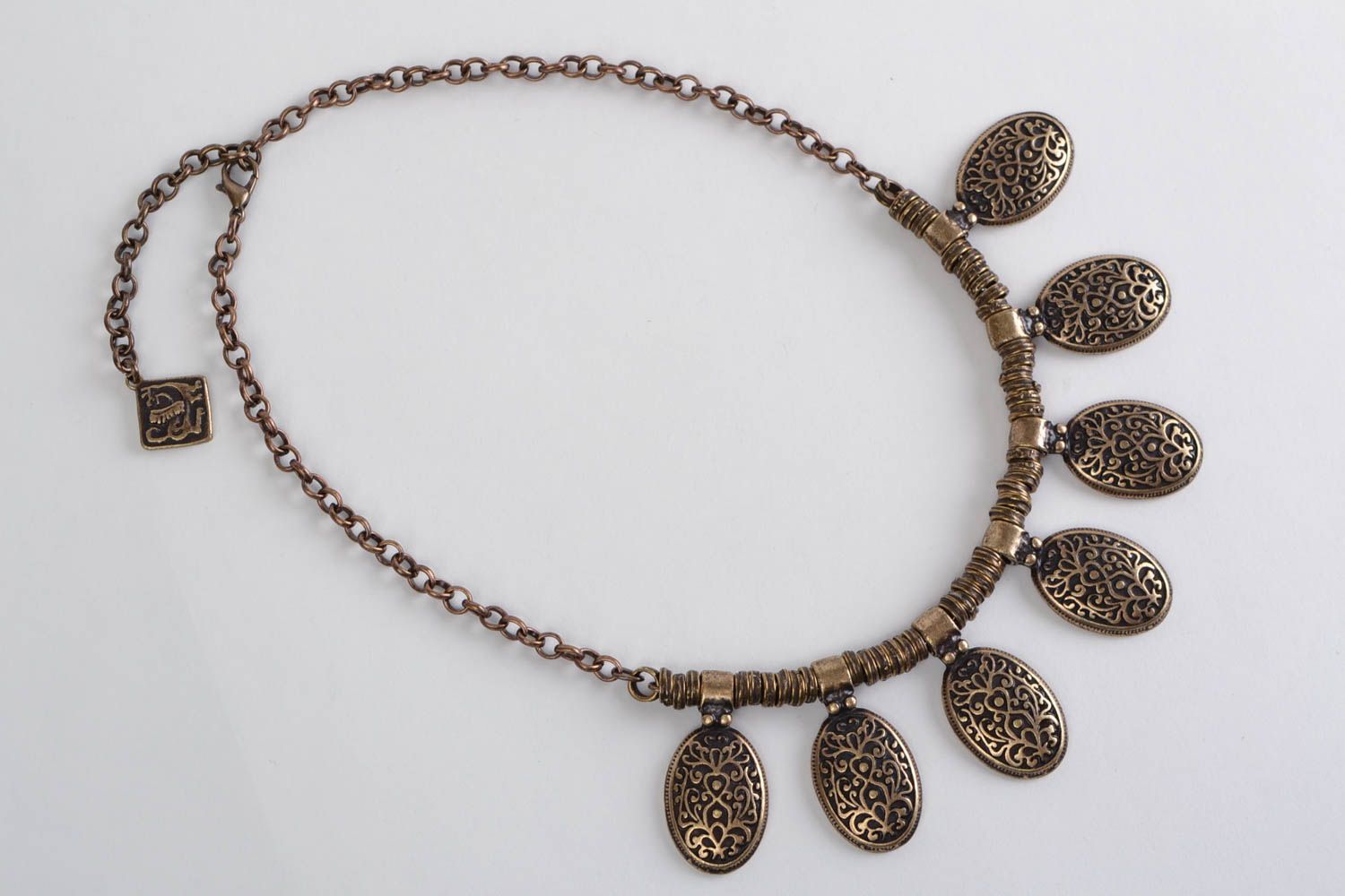 Handmade designer metal necklace of bronze color in ethnic style photo 2