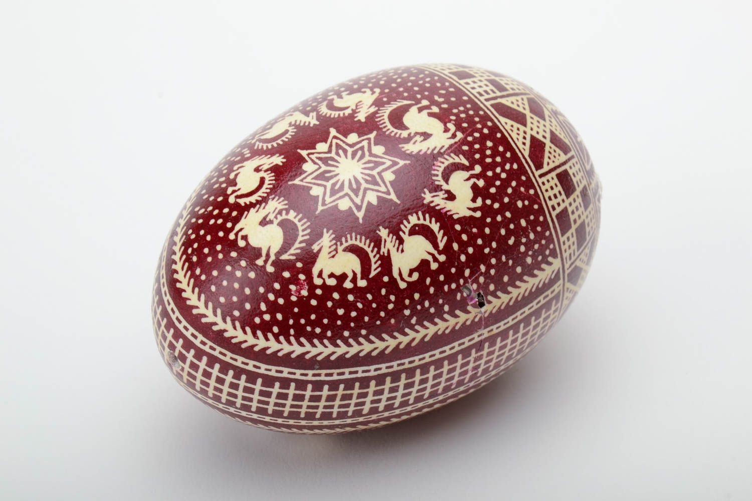 Red and white handmade painted goose egg decorated using waxing technique photo 2