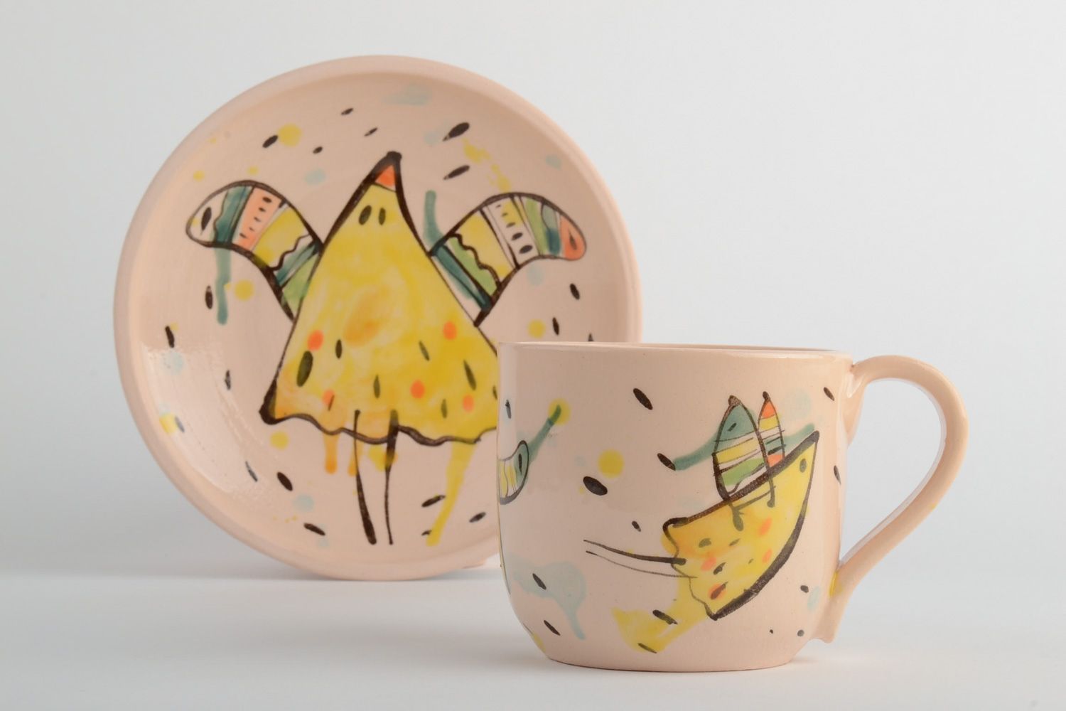Handmade ceramic kids' tea set of a cup and plate in beige color with a funny pattern photo 2