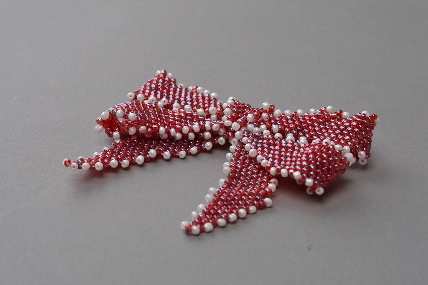 Small handmade brooch in the form of a bow made in red color with white accents photo 3