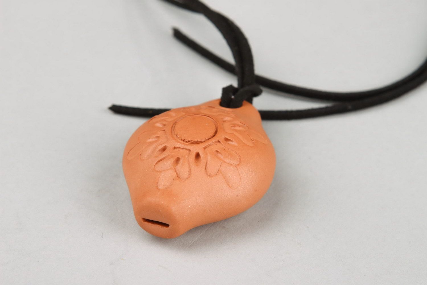 Tin whistle pendant made of clay with solar sign photo 2