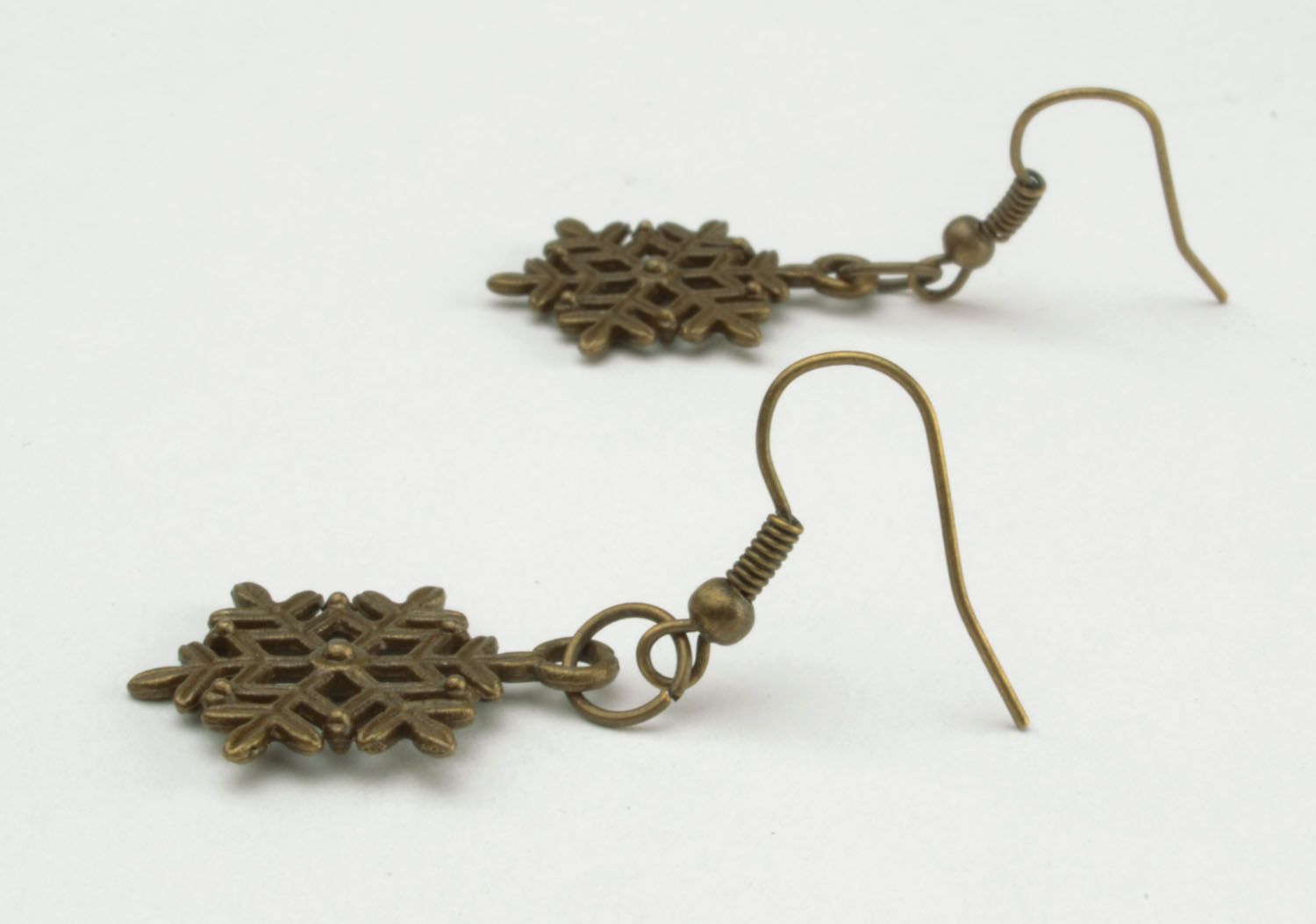 Metal earrings in the shape of snowflakes photo 3