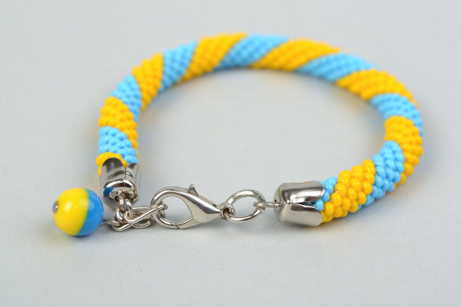 Bright handmade wrist bracelet woven of yellow and blue Czech beads  photo 4