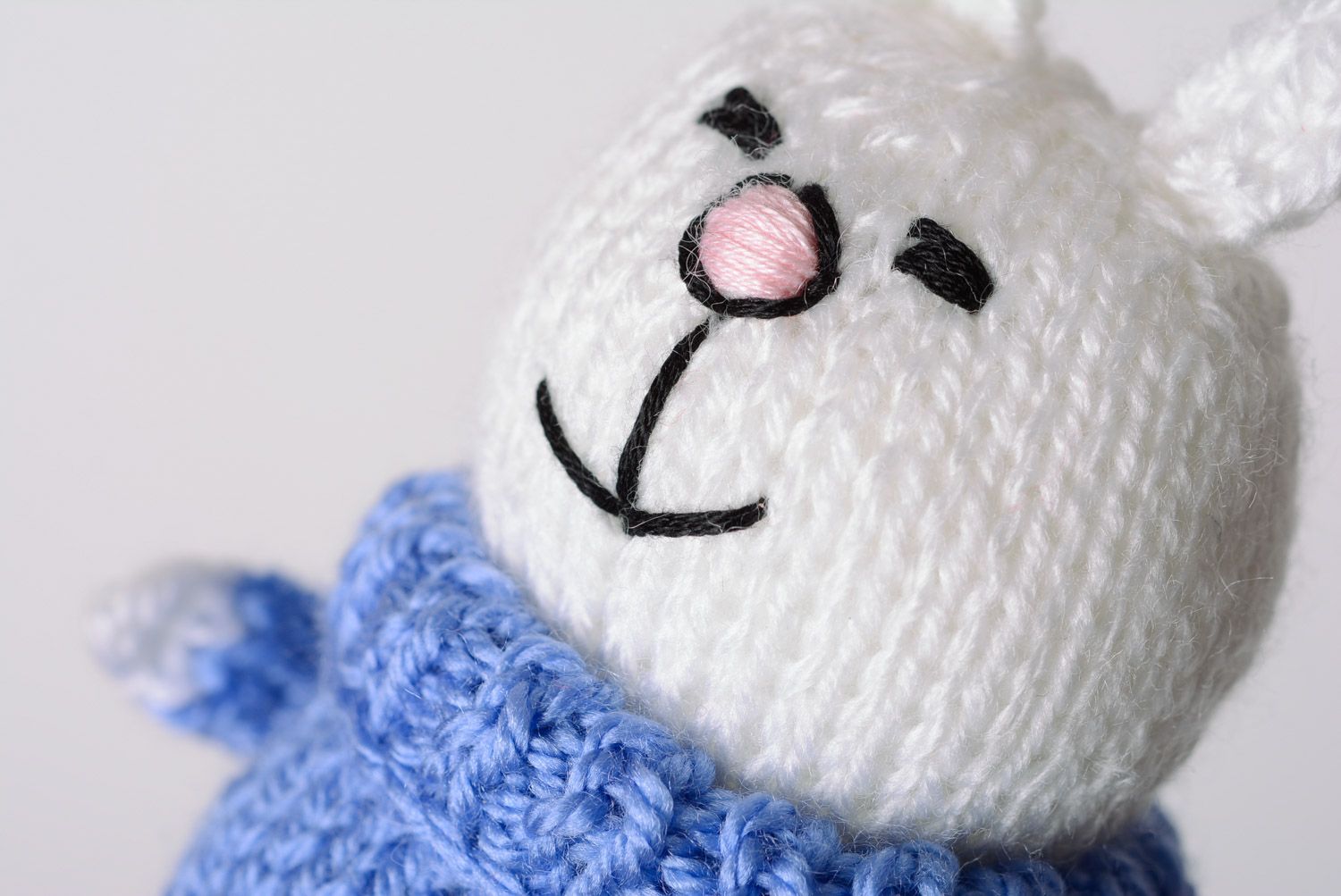 Handmade knitted soft toy smiling white bunny in blue sweater photo 2