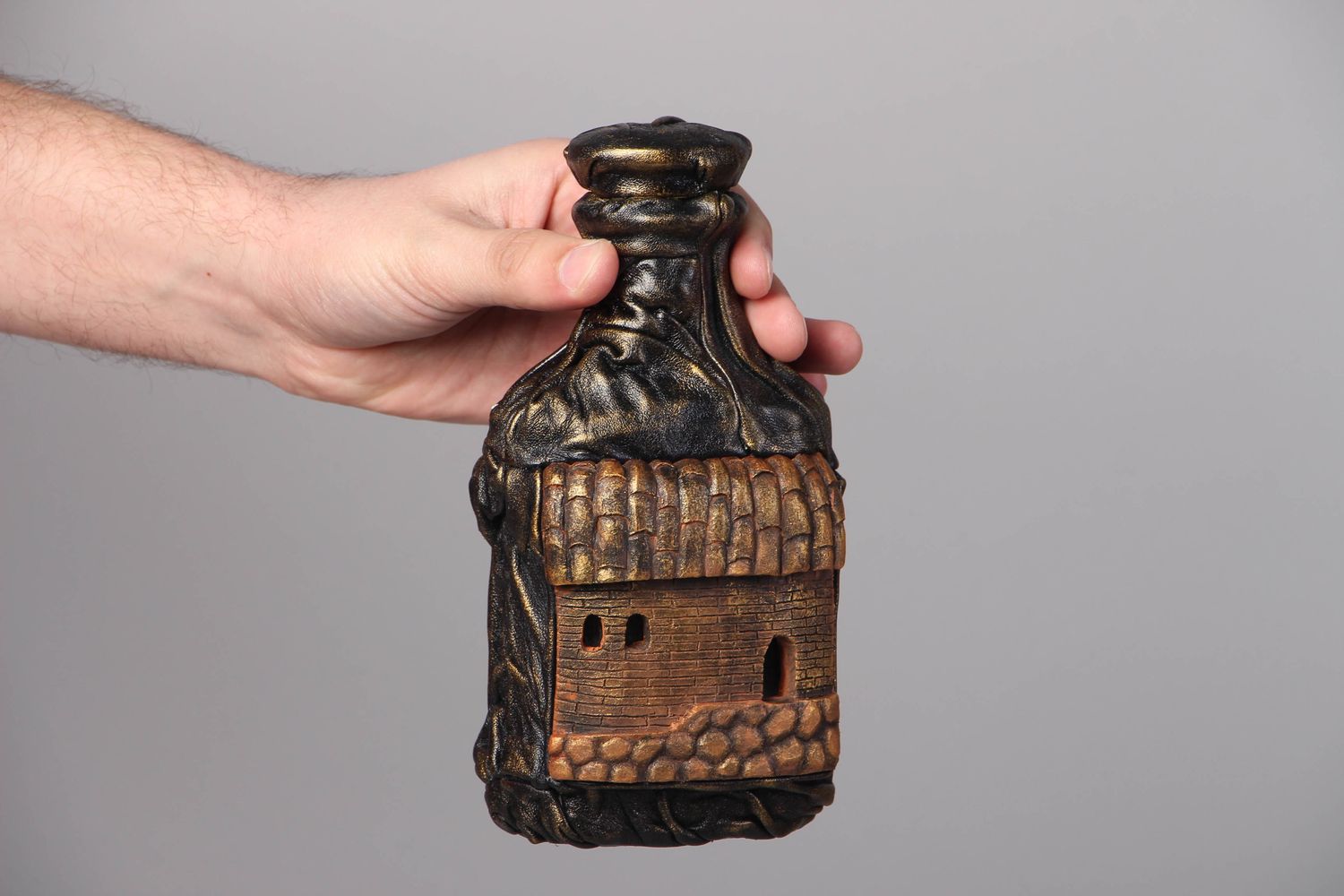 Handmade decorative bottle with leather and clay photo 4