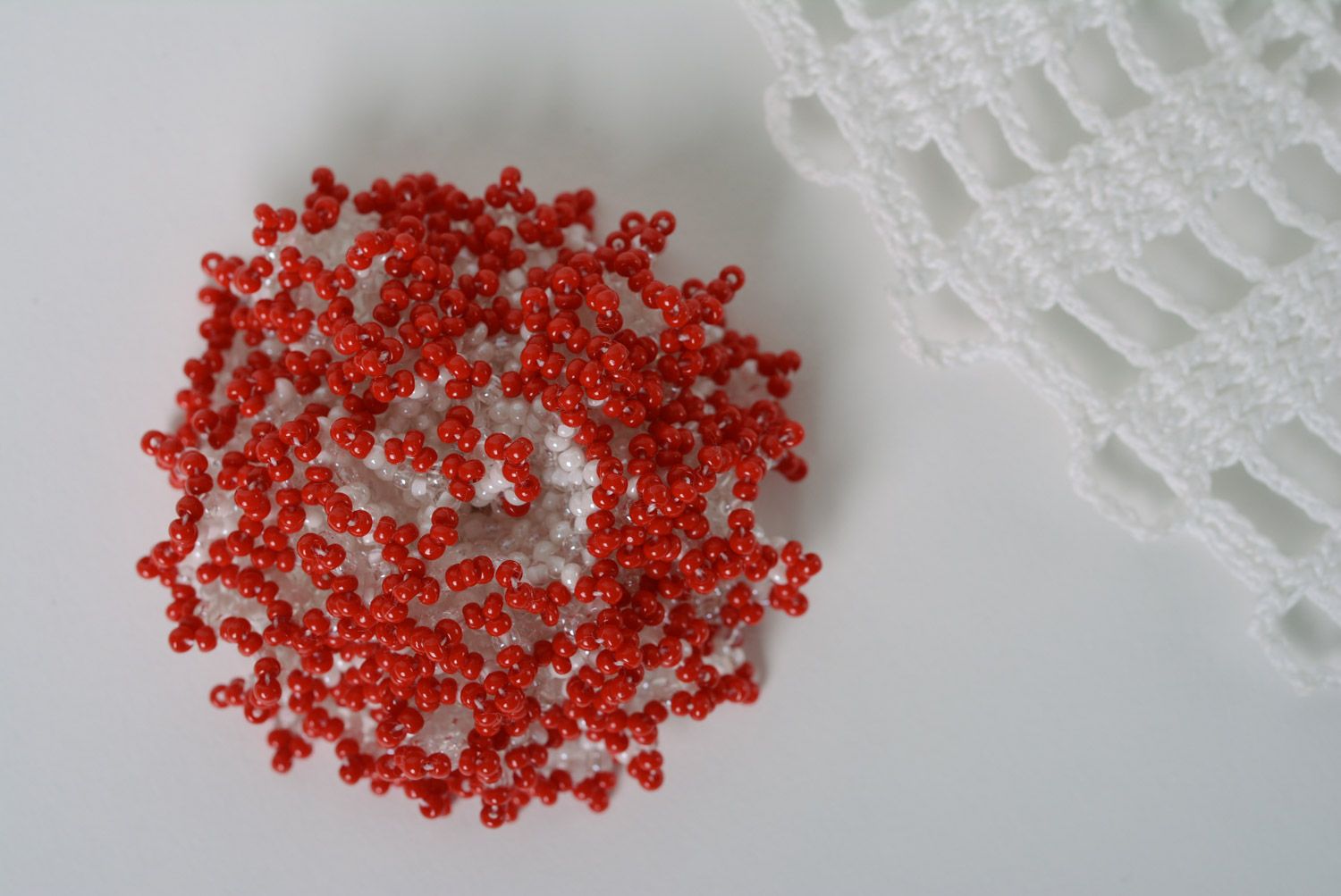 Red and white handmade brooch woven of beads in the shape of volume flower photo 1