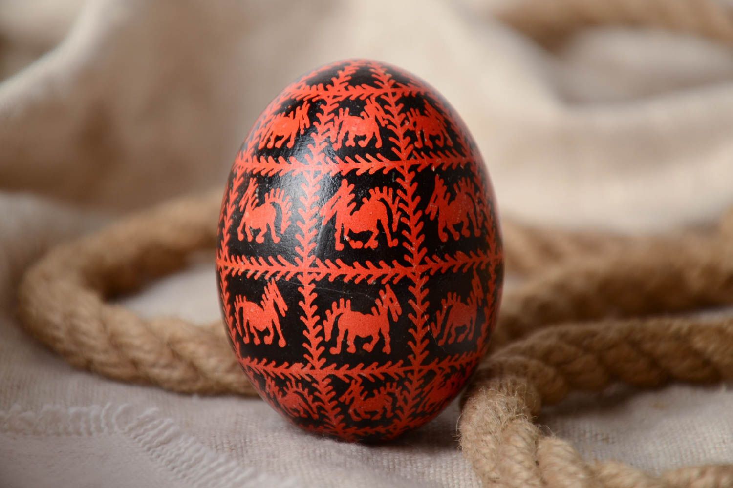 Black and red homemade painted Easter egg decorated using waxing technique photo 1