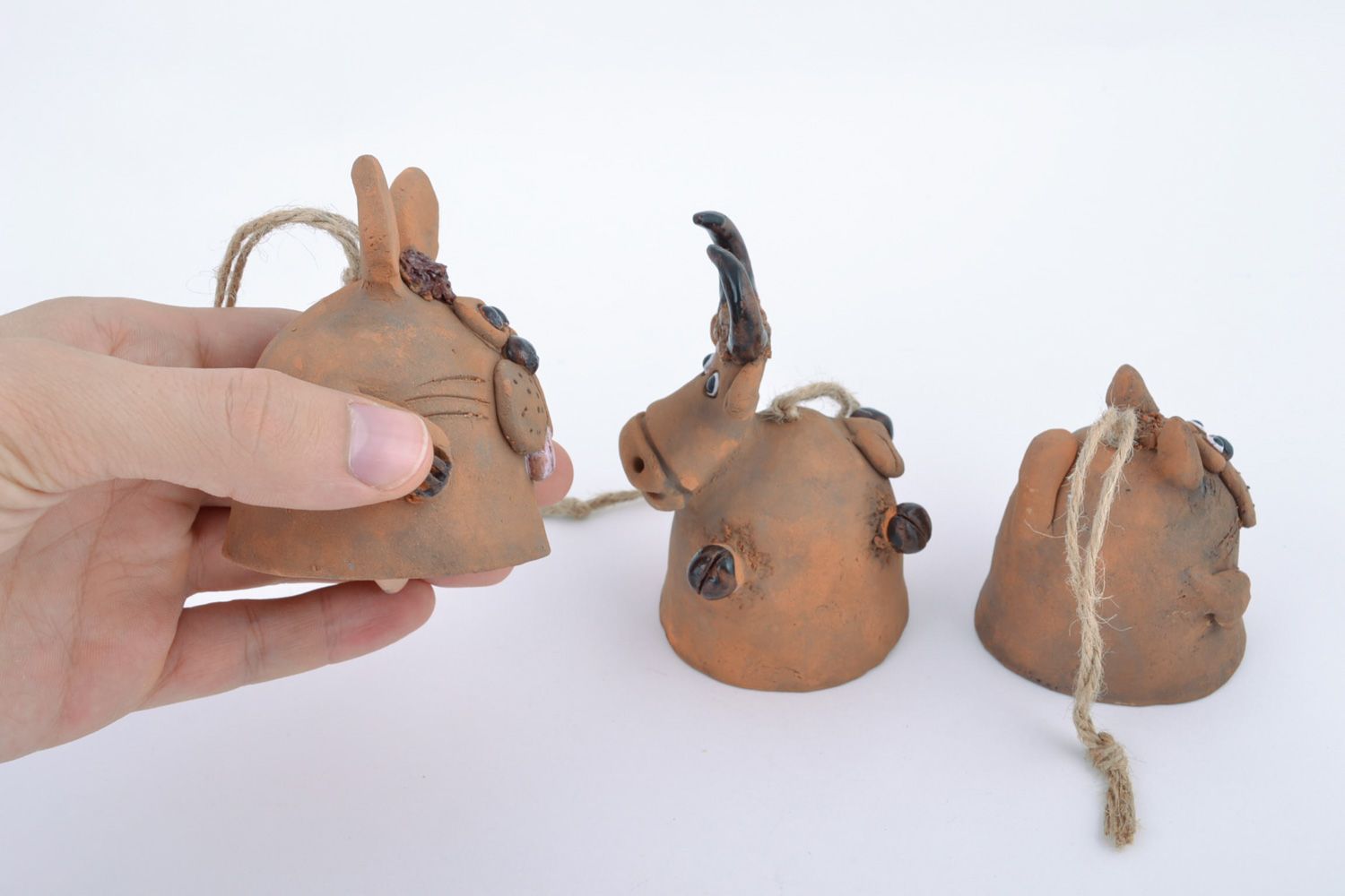 Set of handmade ceramic hanging bells in the shape of traditional toys animals photo 2