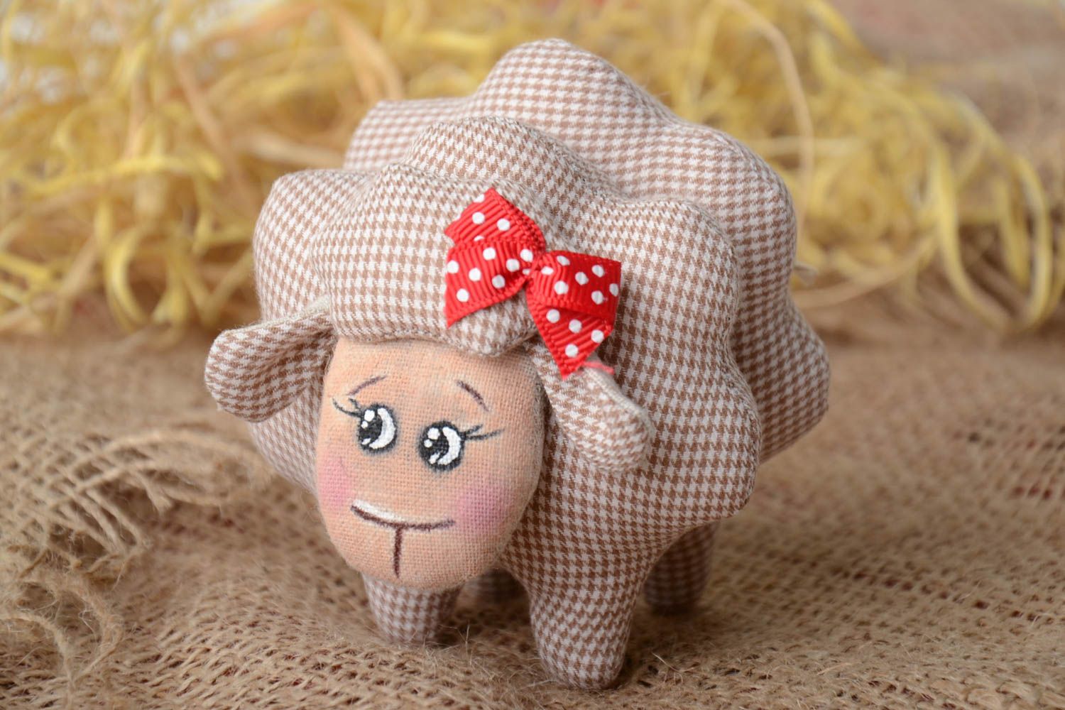 Handmade small soft toy sewn of checkered beige cotton fabric lamb with red bow photo 1