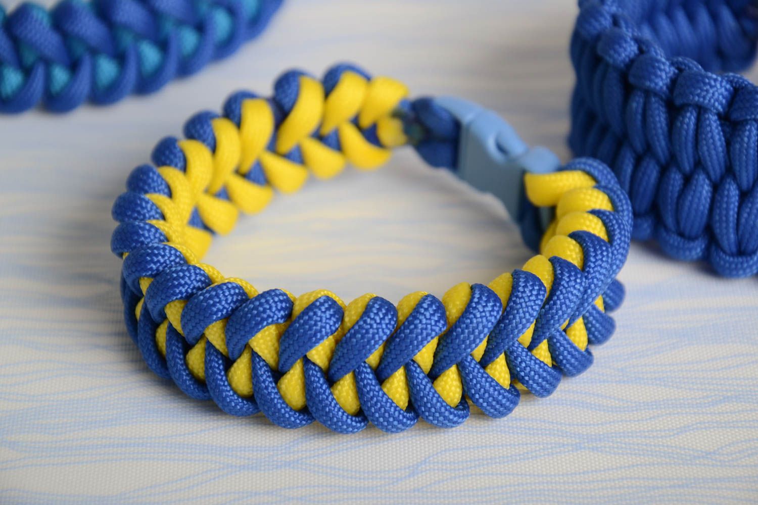 Handmade braided bracelet made of parachute cord blue and yellow unisex accessory photo 1