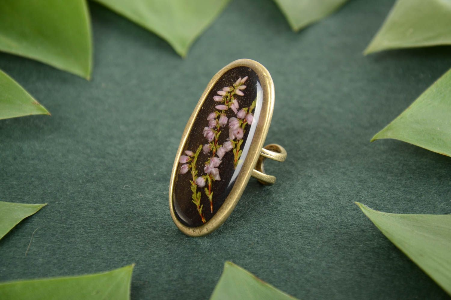 Beautiful women's handmade oval top ring with dried flowers coated with epoxy photo 1