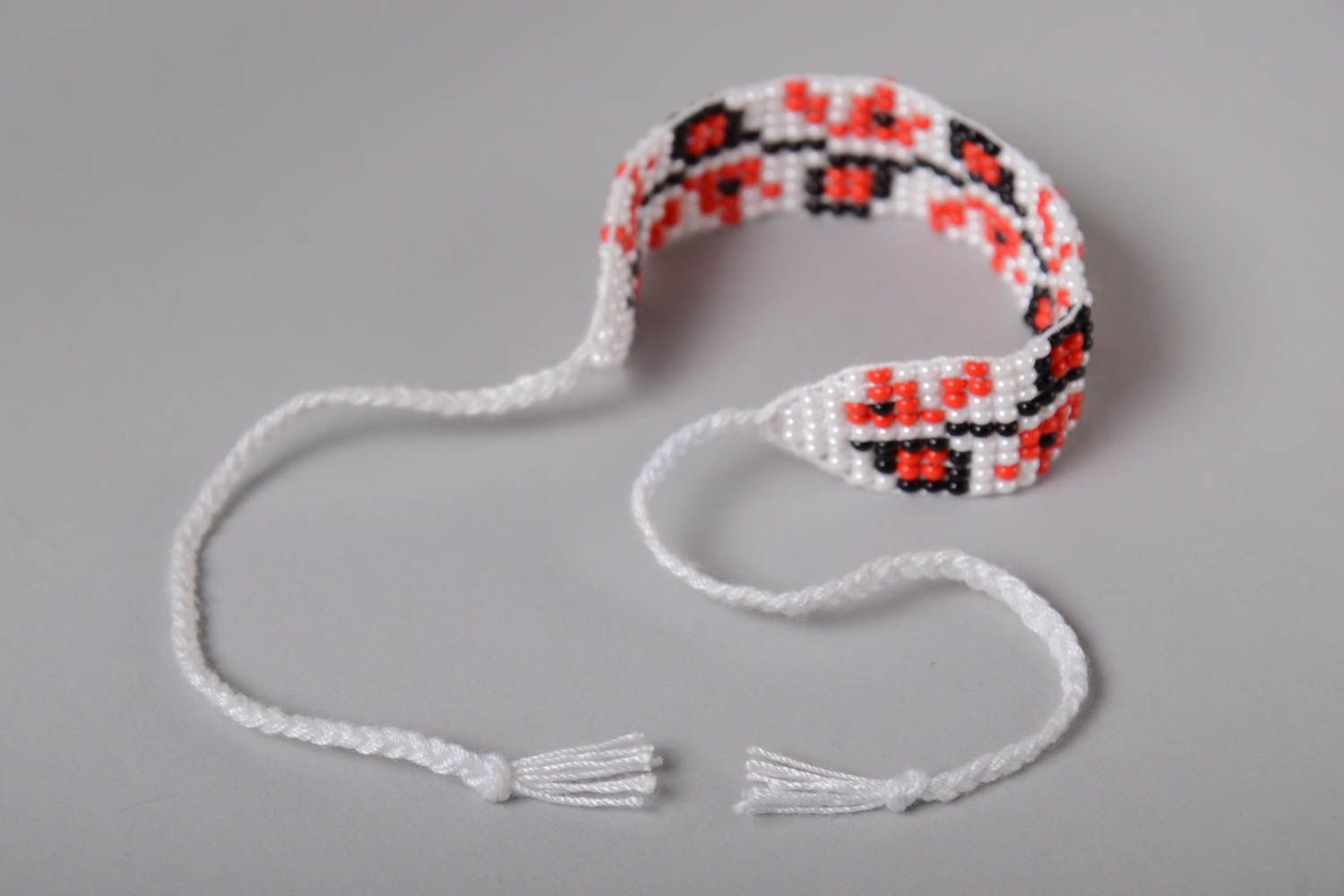 Handmade knitted beaded strand bracelet with Ukrainian ornament in red, black, and white color photo 5