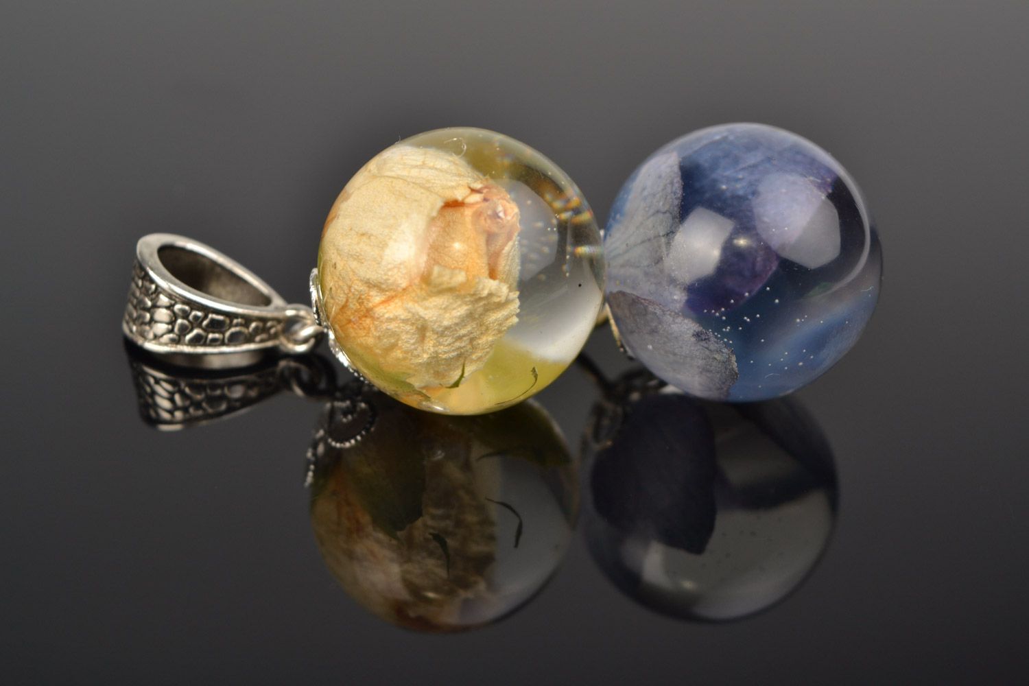 Set of two ball-shaped pendants with natural flowers in epoxy resin on chains  photo 1