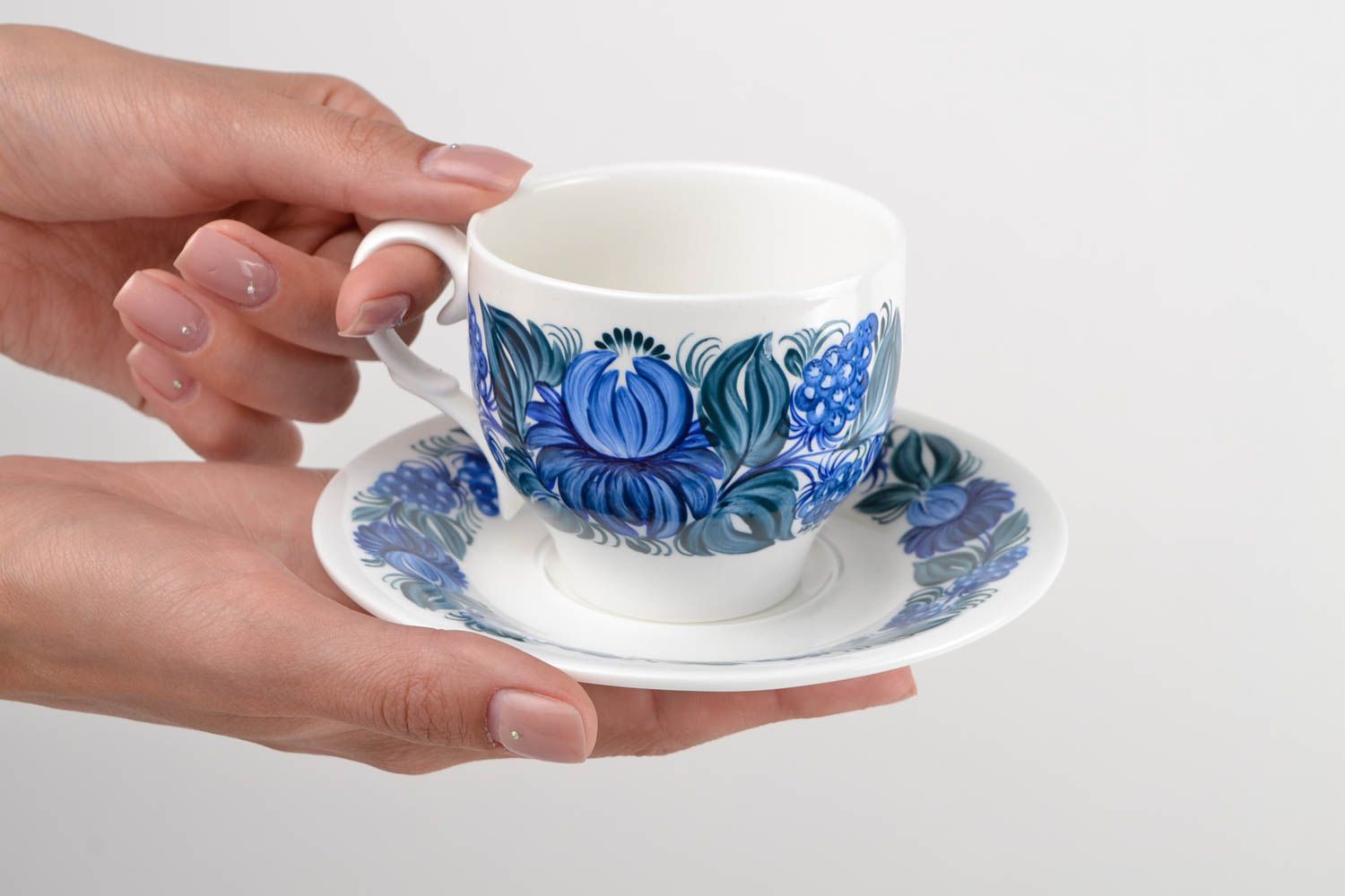 White porcelain cup with handle and saucer with blue floral pattern in Russian style photo 2