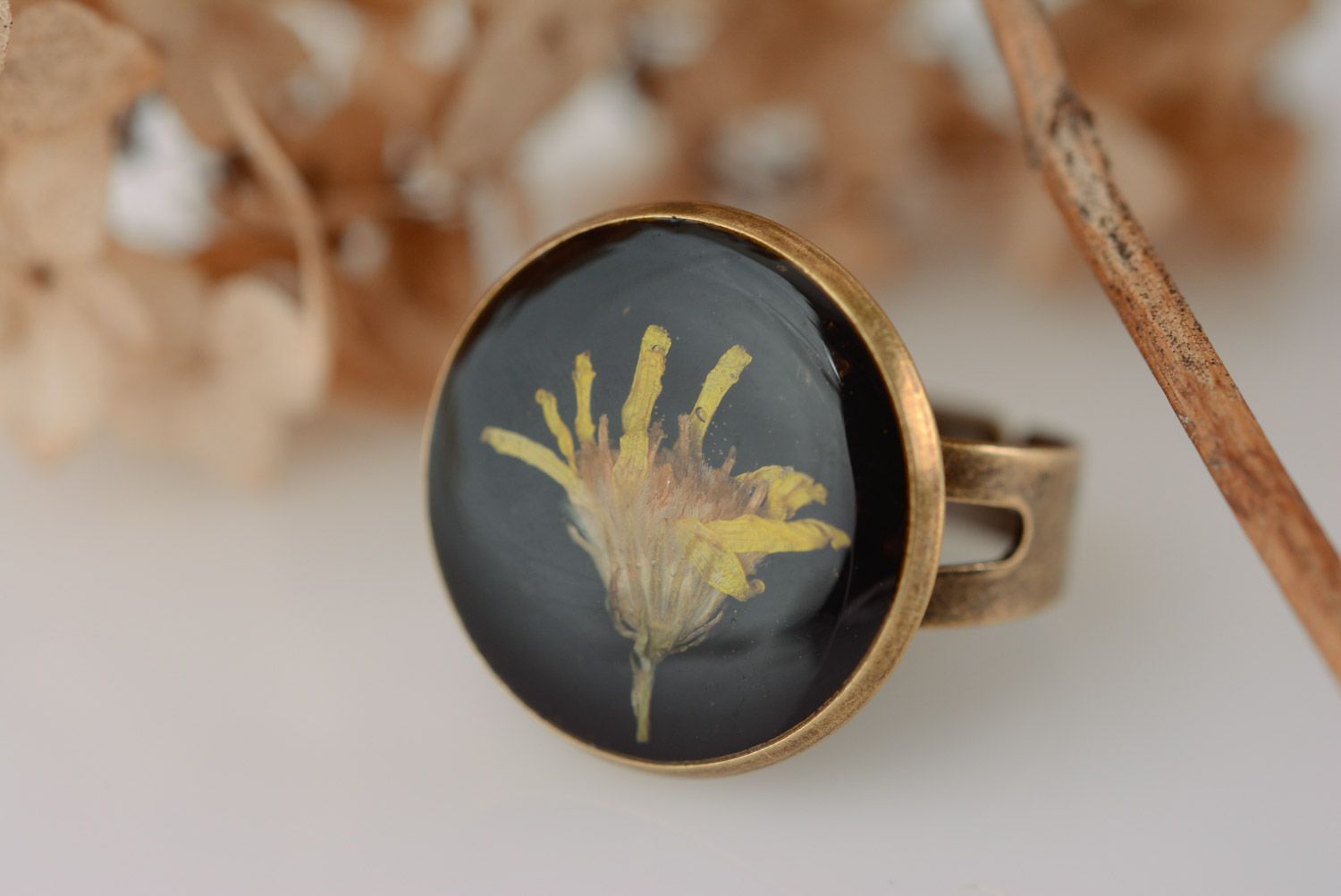 Handmade round black ring with yellow dried flower in epoxy resin for women photo 1