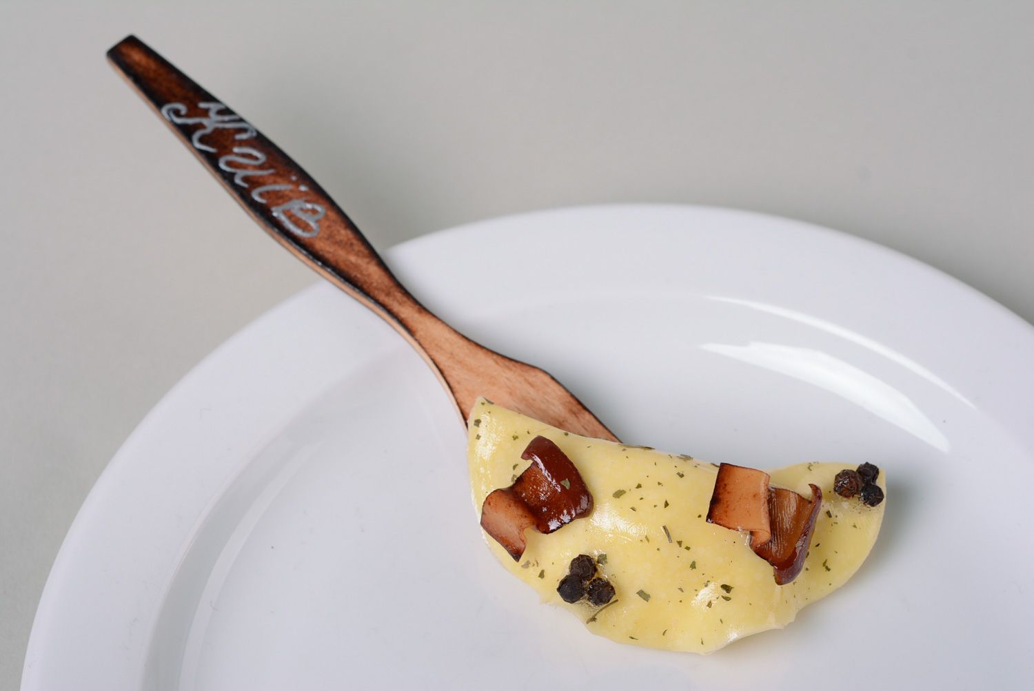Handmade decorative polymer clay fridge magnet for kitchen dumpling on wooden fork photo 1