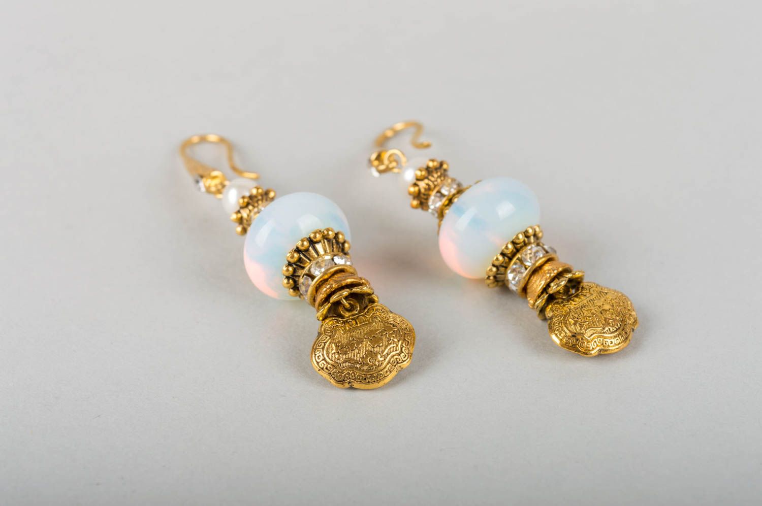 Beautiful female earrings with charms made of metal with pearls and moonstone photo 3