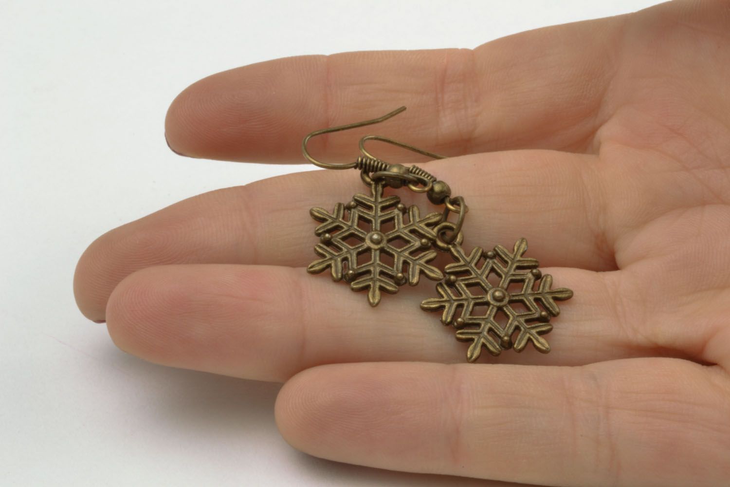 Metal earrings in the shape of snowflakes photo 2