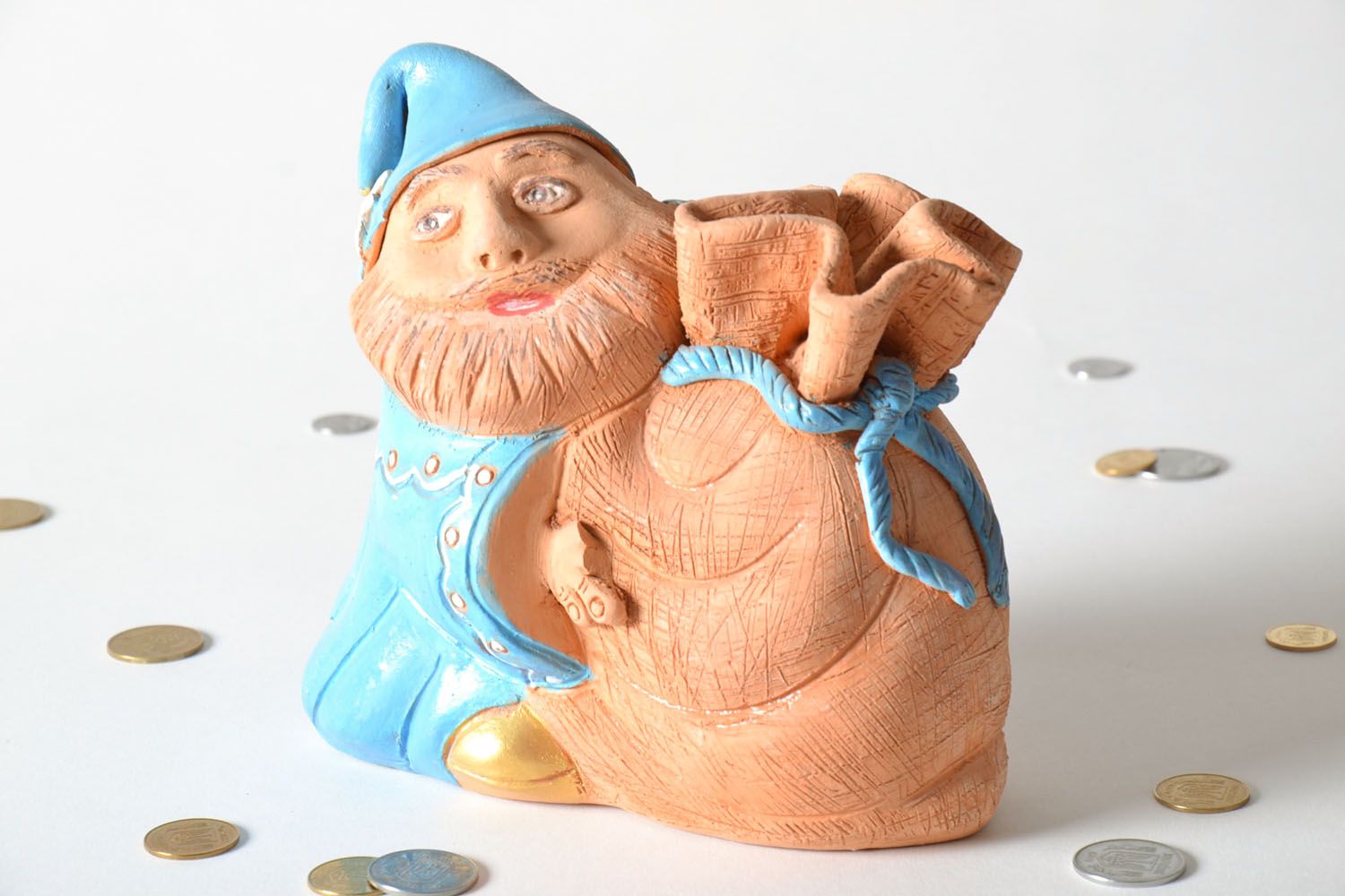 Clay money box in the shape of a man with a sack photo 1