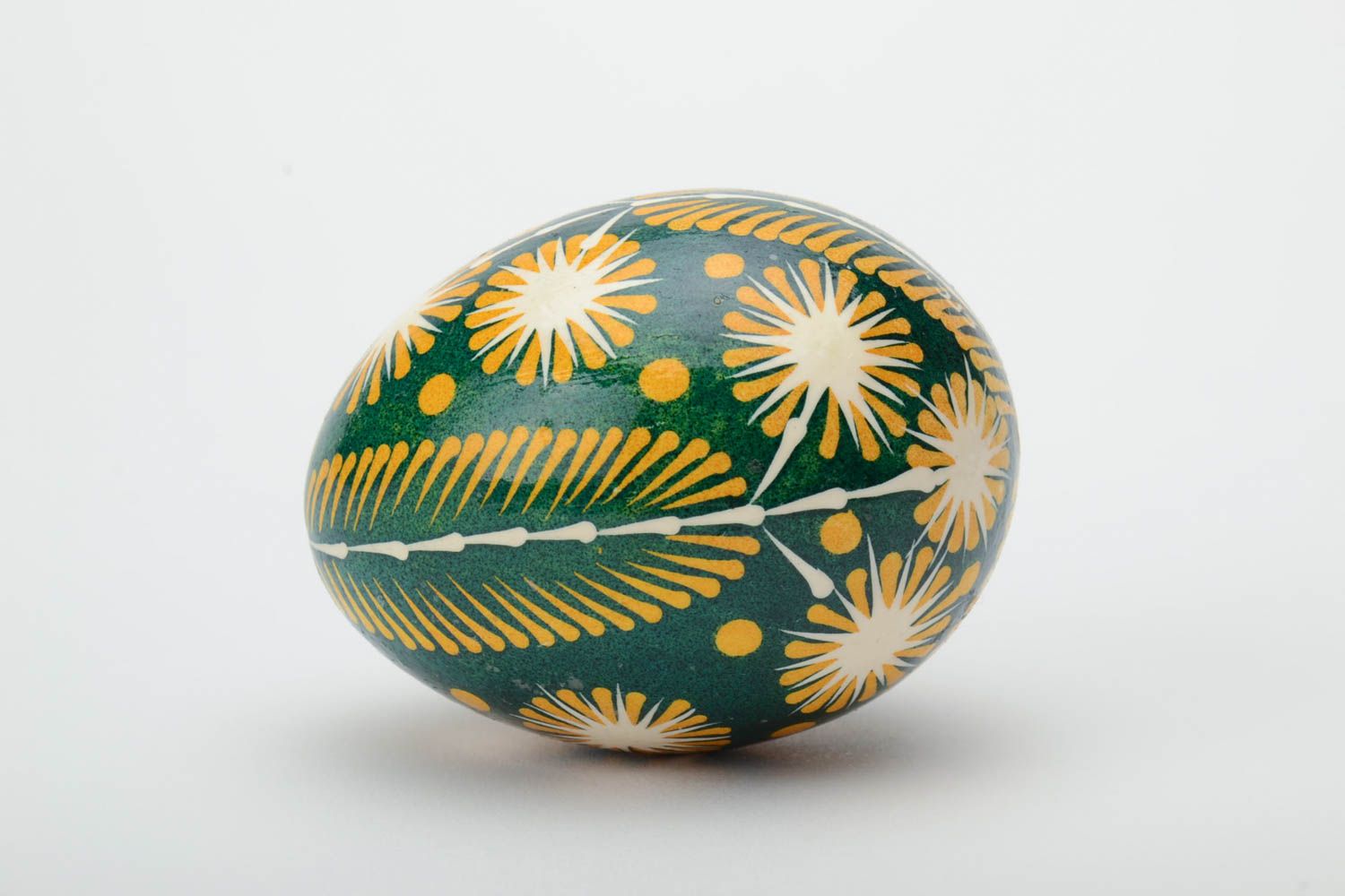 Green and yellow handmade painted Easter egg ornamented using waxing technique photo 3