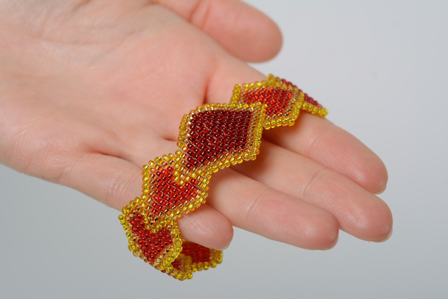 Handmade designer wrist bracelet woven of beads in yellow and red colors  photo 3