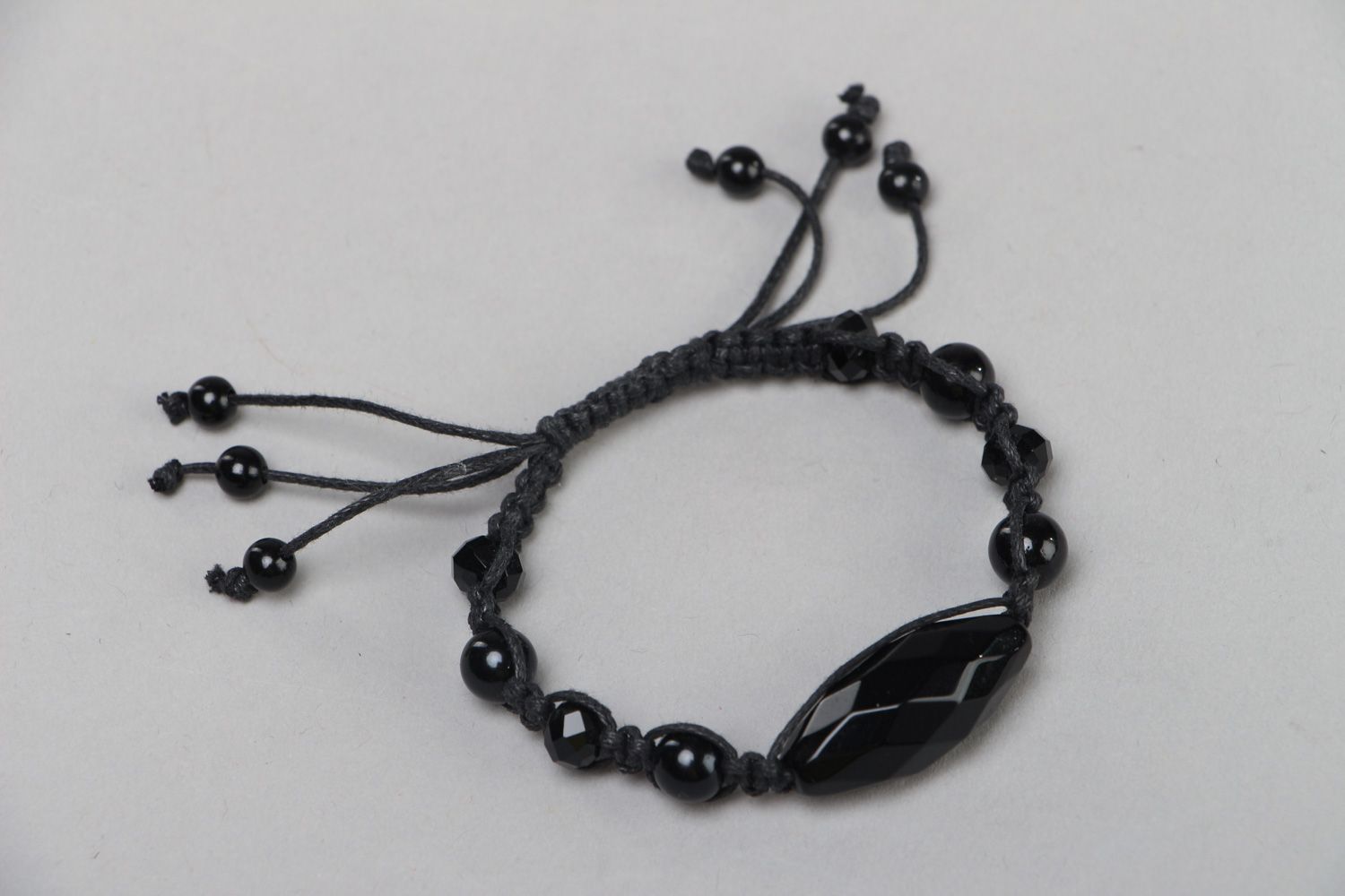 Black designer bracelet hand made of beads and cord photo 1