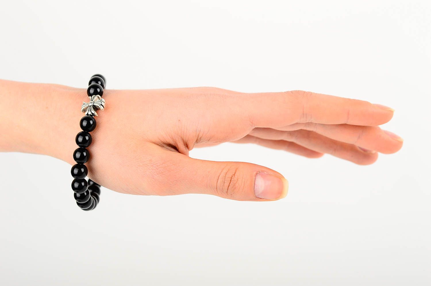 Metal cross and black beads unisex bracelet on an elastic string photo 2