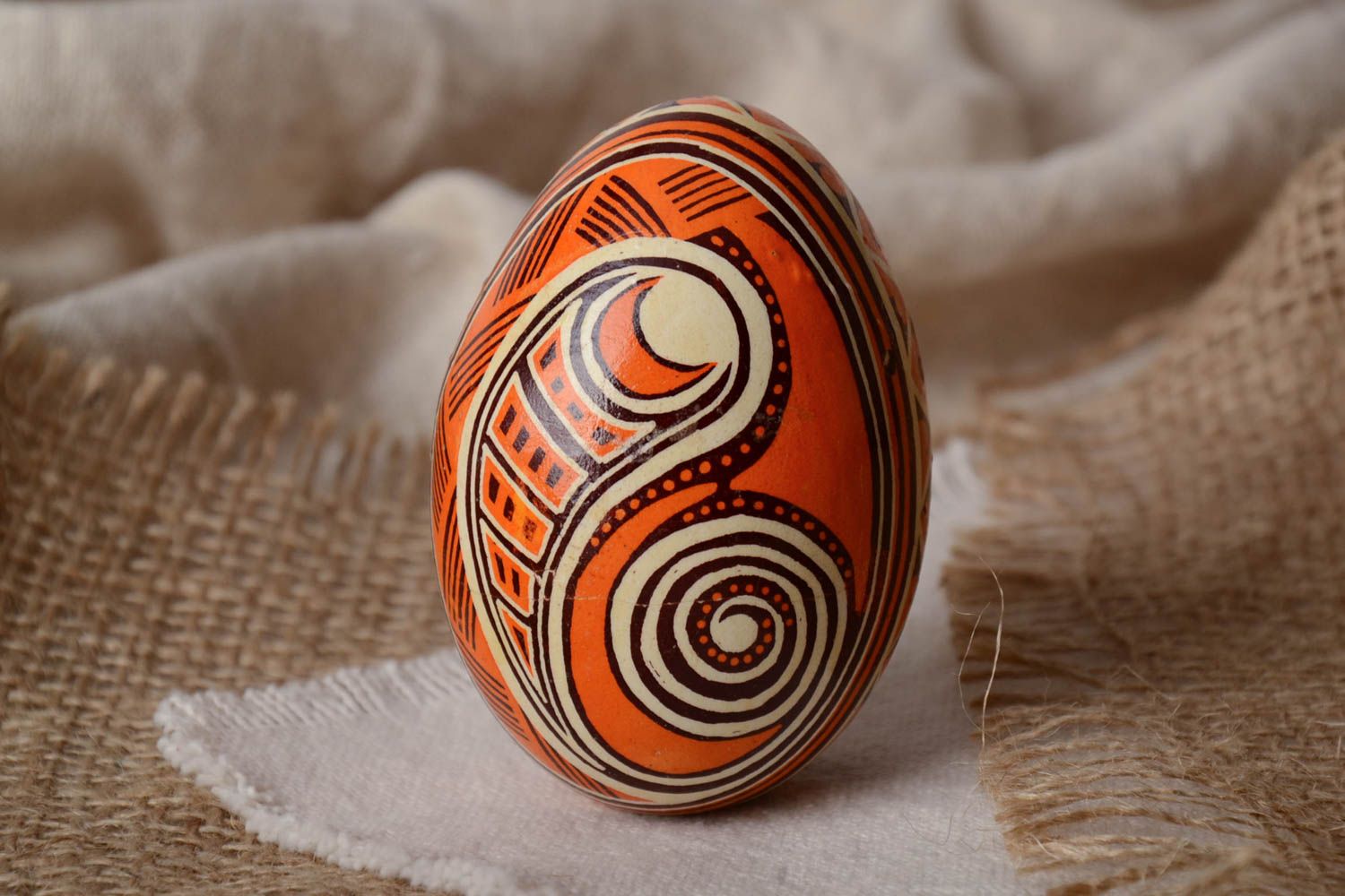 Unusual handmade orange painted Easter egg decorated using waxing technique photo 1