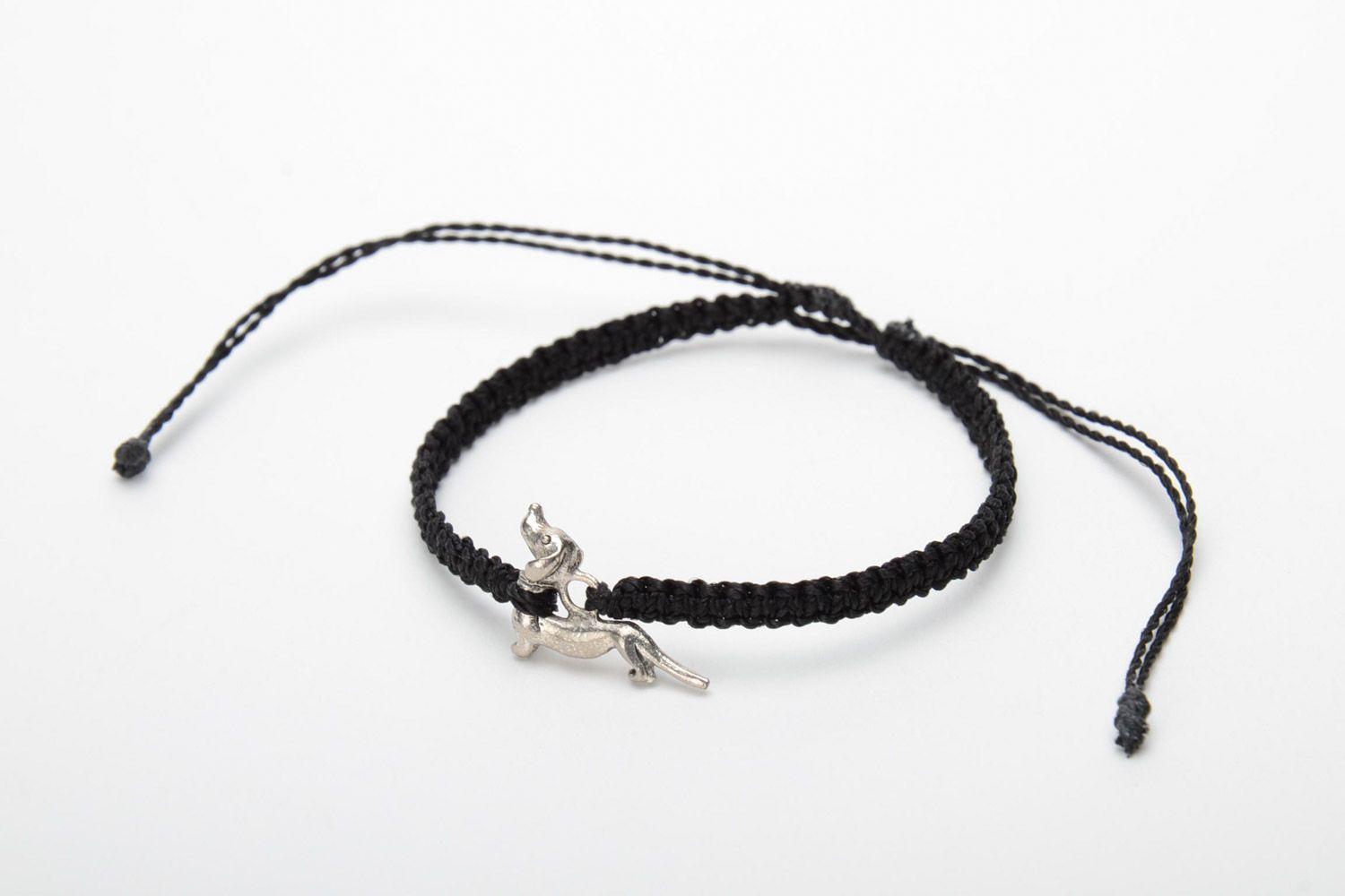 Handmade friendship bracelet woven of gray threads with a badger-dog charm photo 3