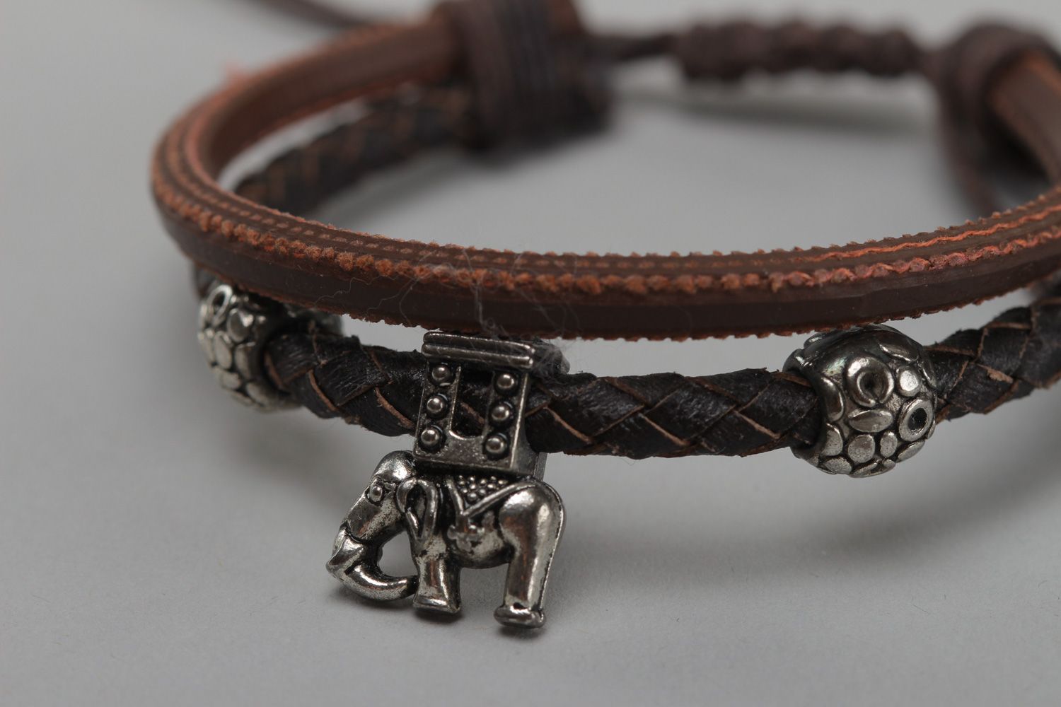 Handmade women's wrist bracelet woven of genuine leather of brown color photo 3