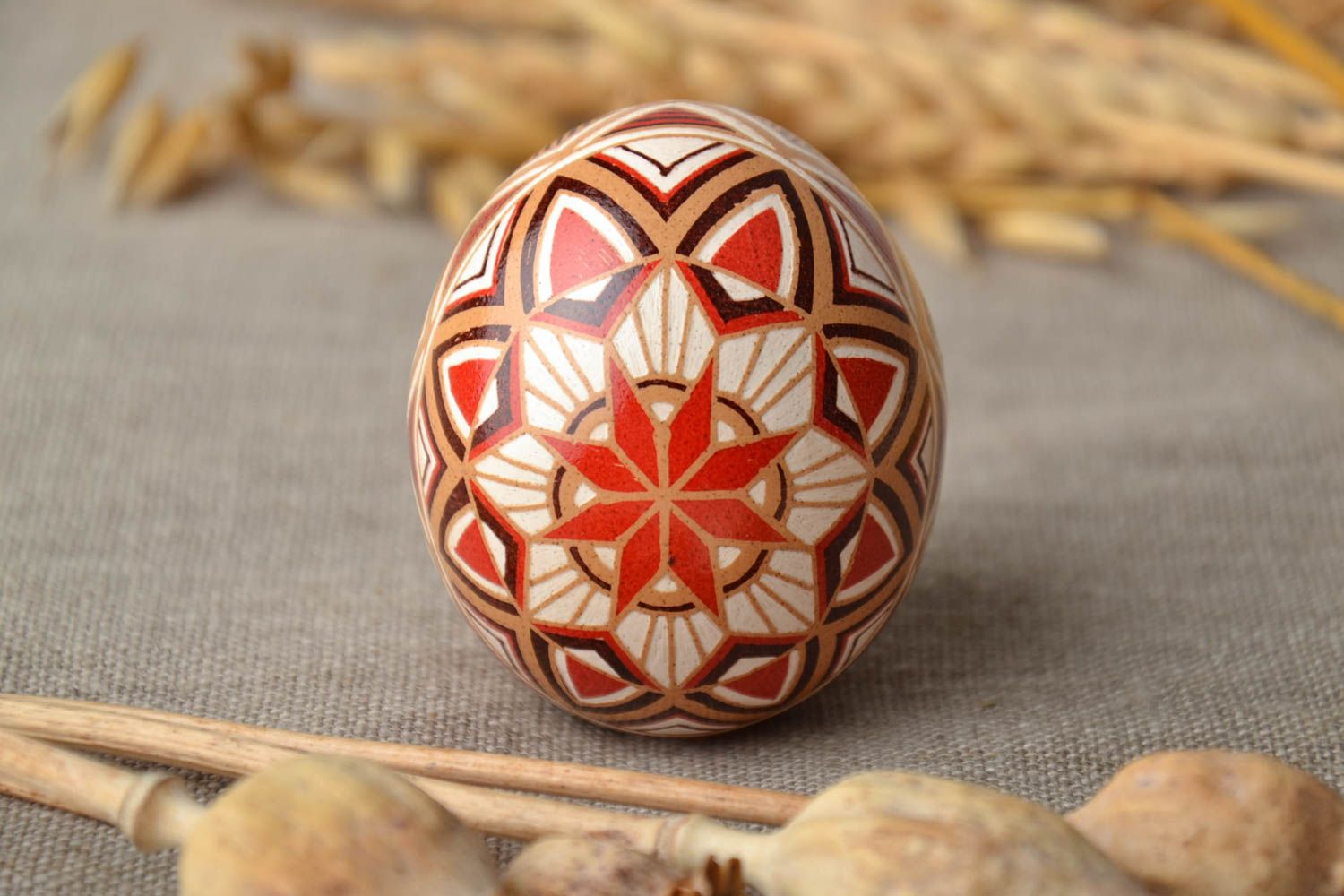 Handmade pysanka painted with hot wax with traditional symbols photo 1