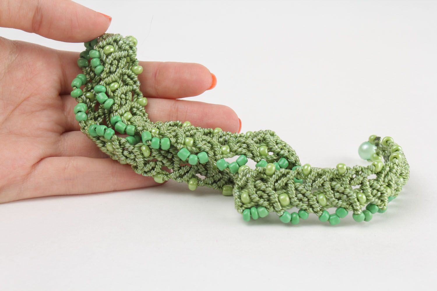 Green necklace made of threads and beads photo 2