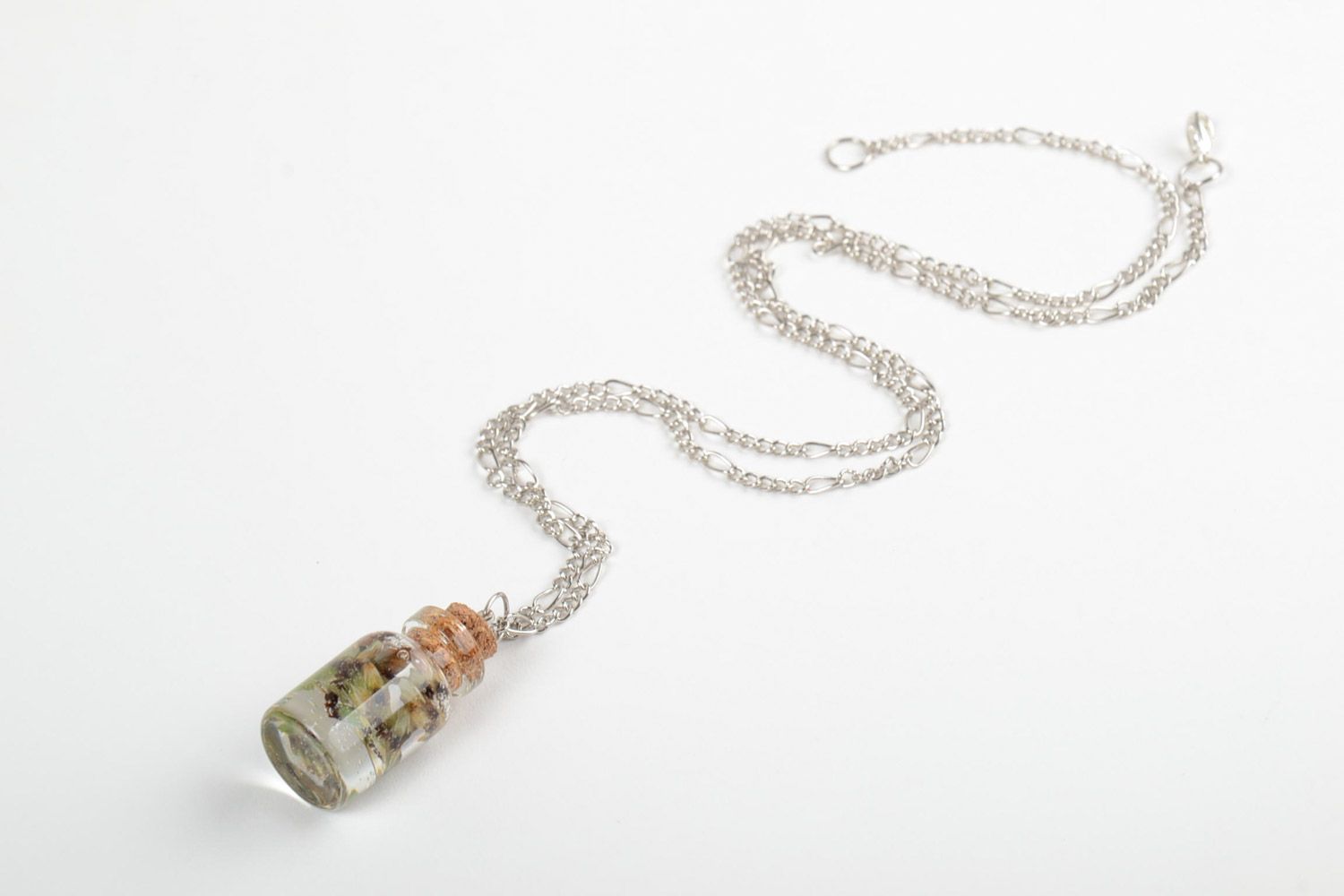Handmade neck pendant with real flowers coated with epoxy in the shape of transparent vial photo 3