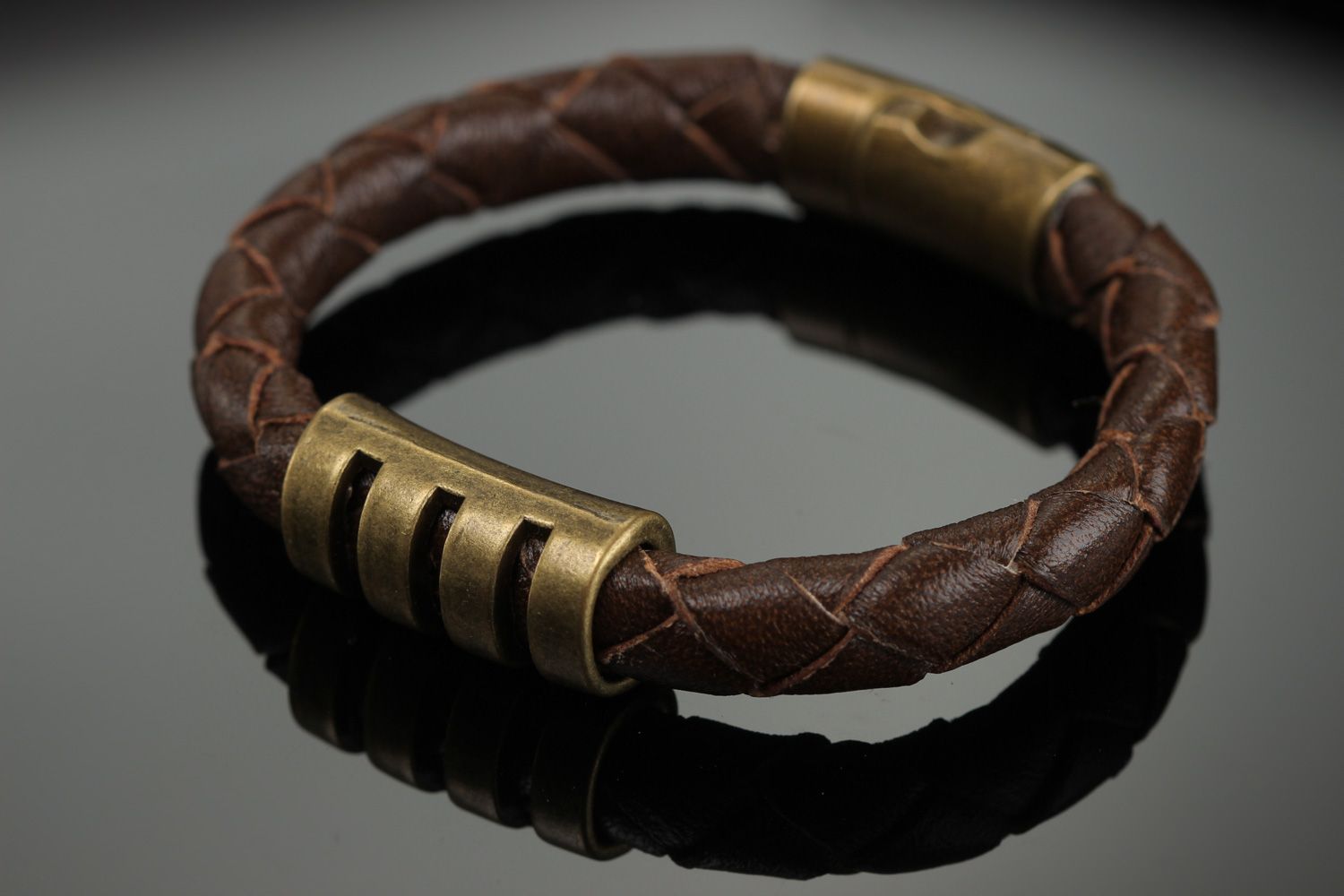 Handmade wrist bracelet woven of brown genuine leather with metal inserts photo 1