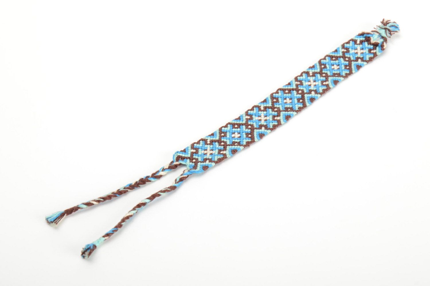 Handmade friendship wrist bracelet woven of threads with blue and brown ornament photo 2